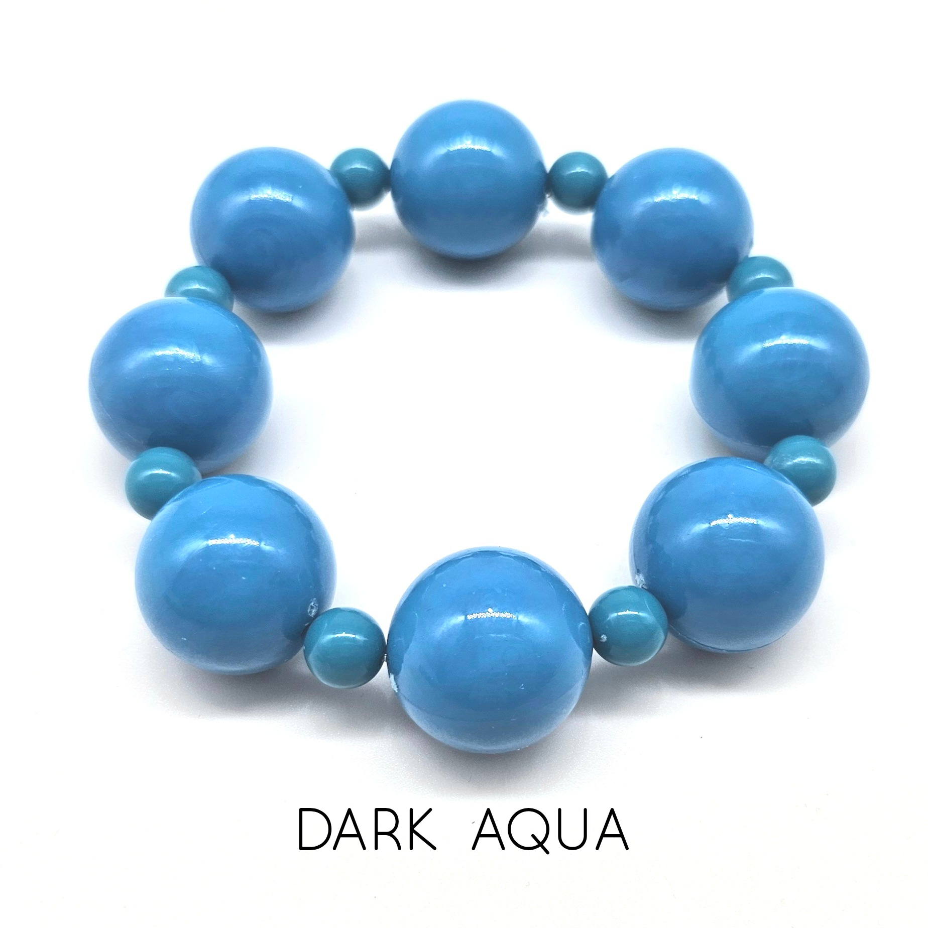 Blue beaded bracelet on a white background with &