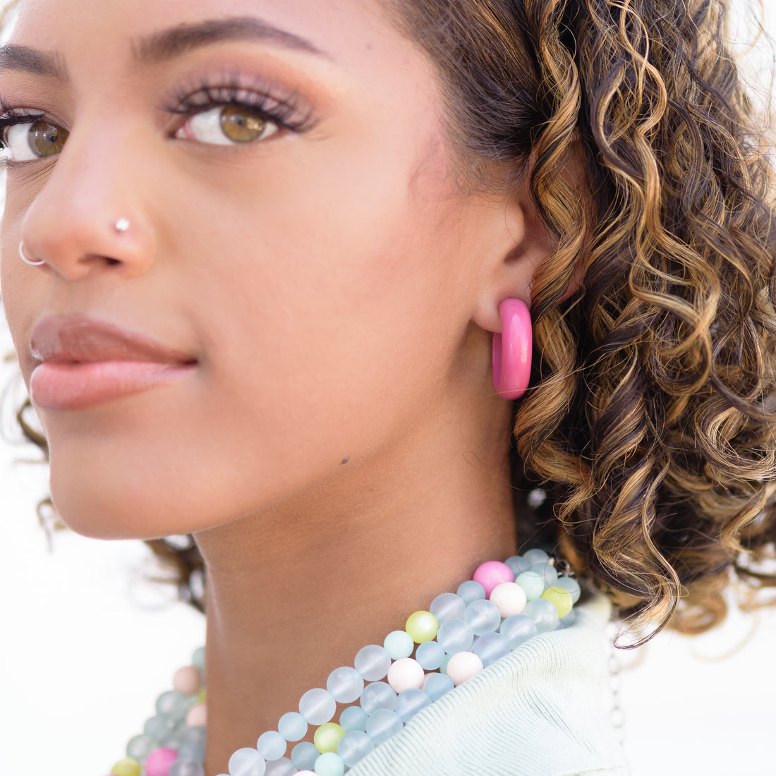 simple hoop earrings on girl with curly hair