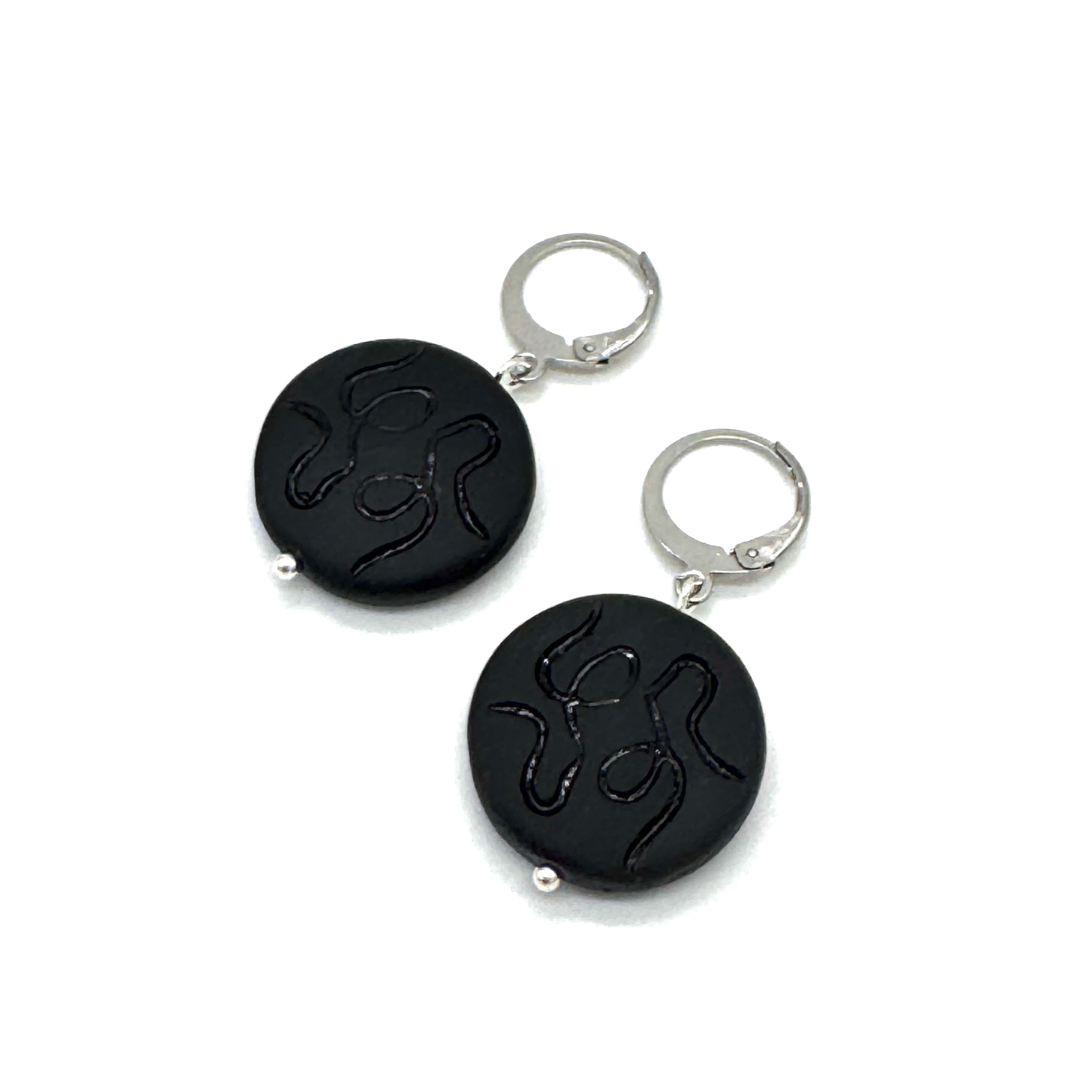Black round keychains with silver loops on a white background