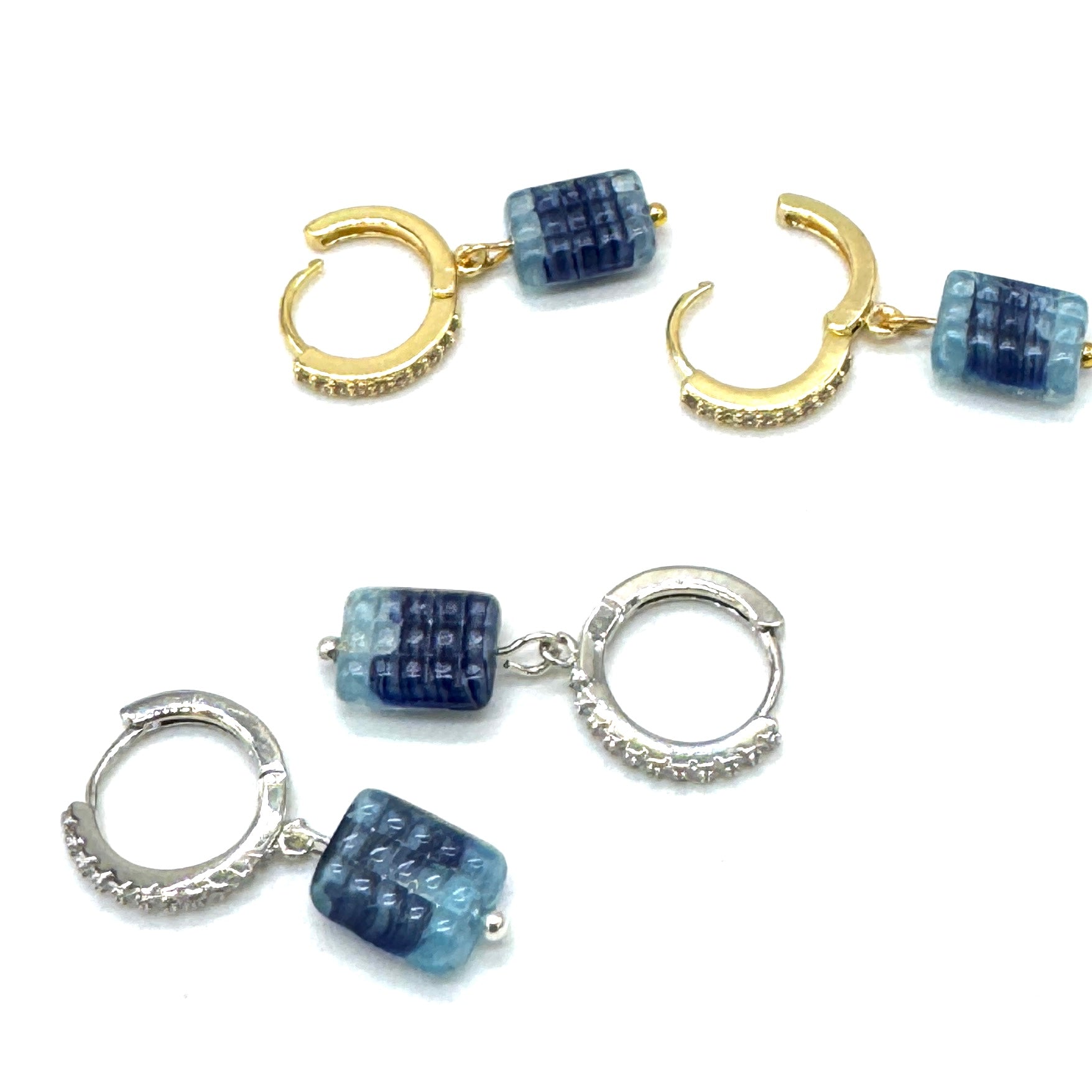 Pair of hoop earrings with blue square beads on a white background