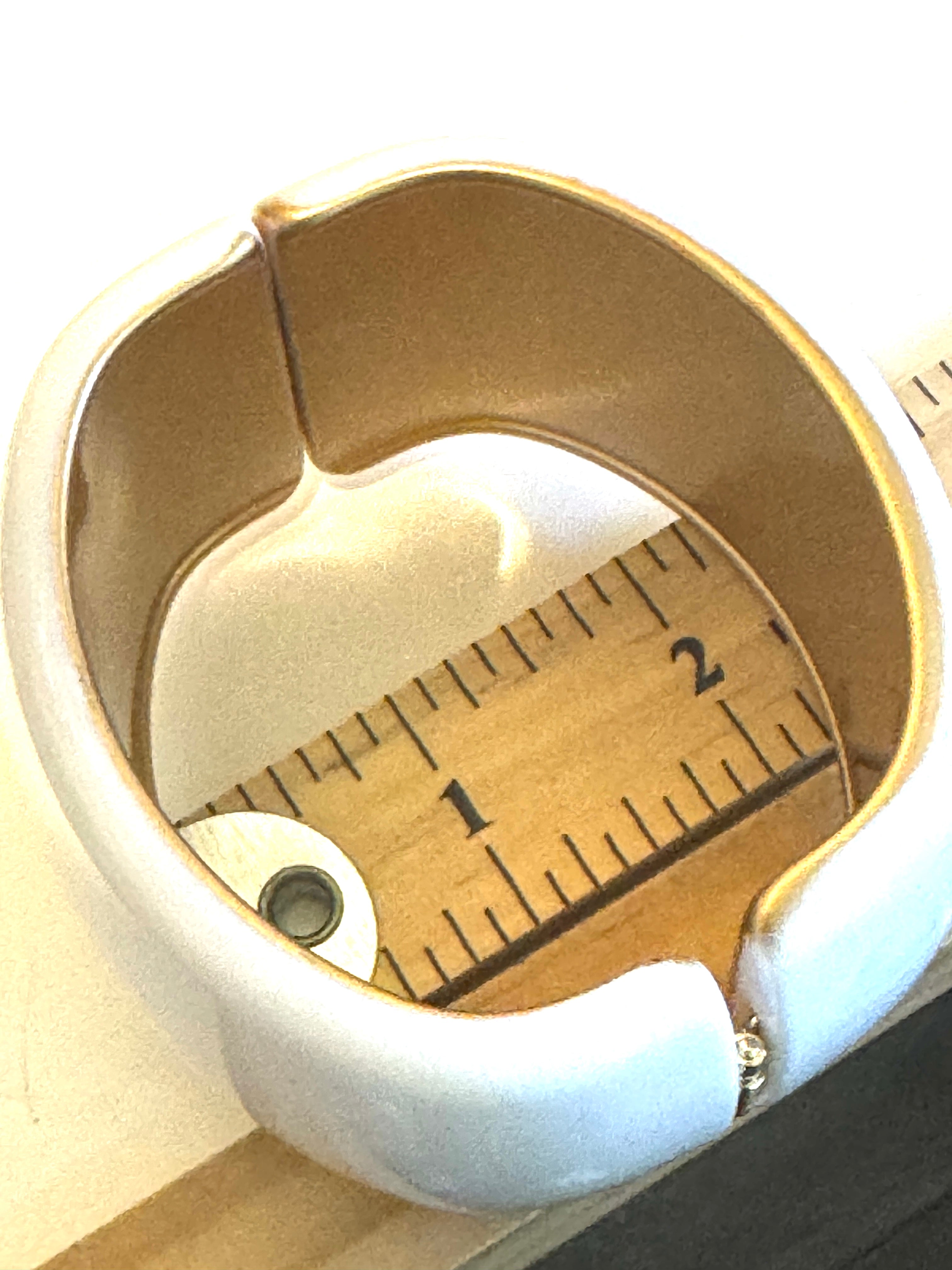 white lucite clamper cuff bracelet on a ruler