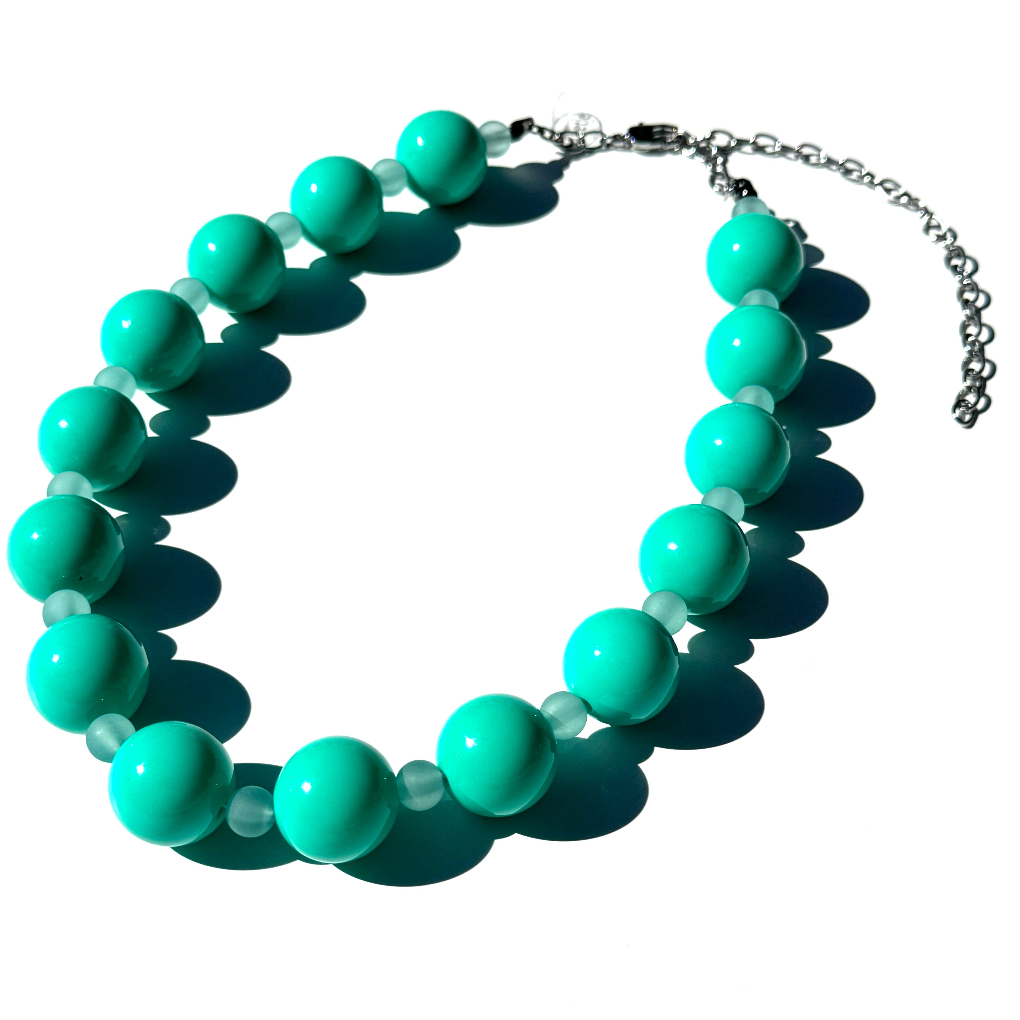 Turquoise beaded necklace on a white background