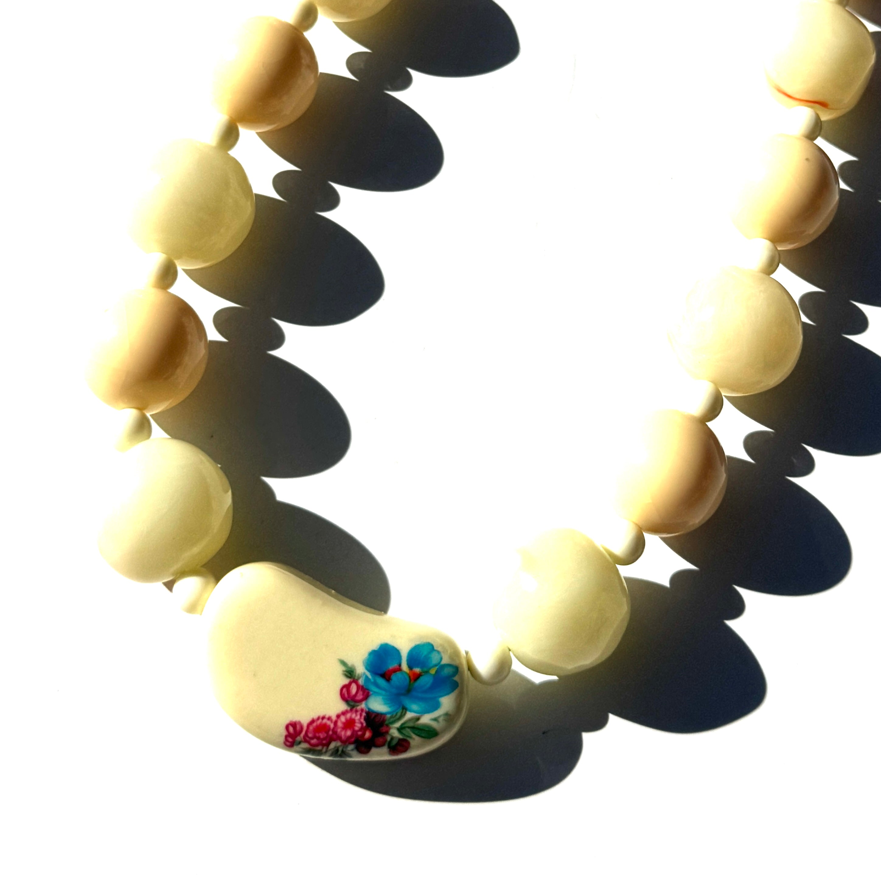 Necklace with decorative pendant on a white background