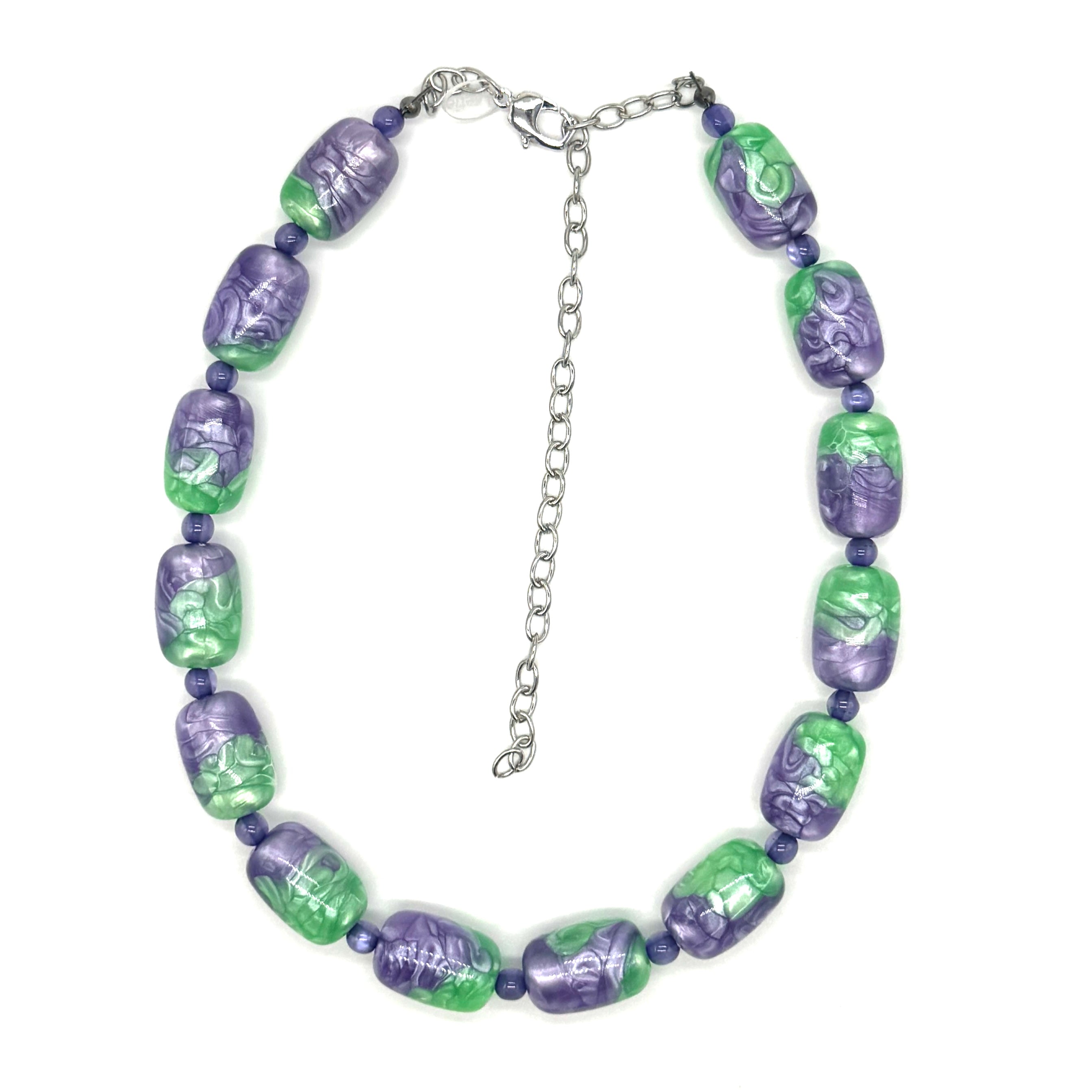 Necklace with green and purple beads on a white background