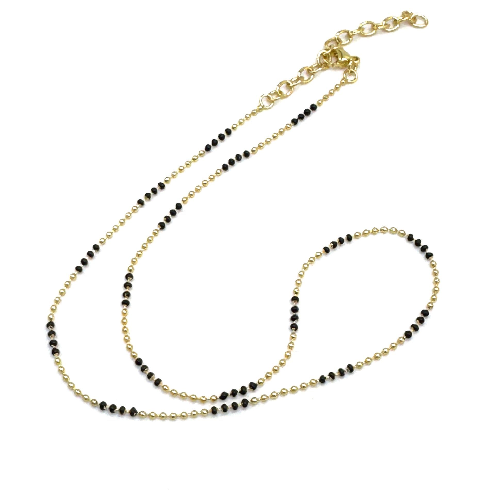 Two beaded necklaces, one gold and one black, on a white background.
