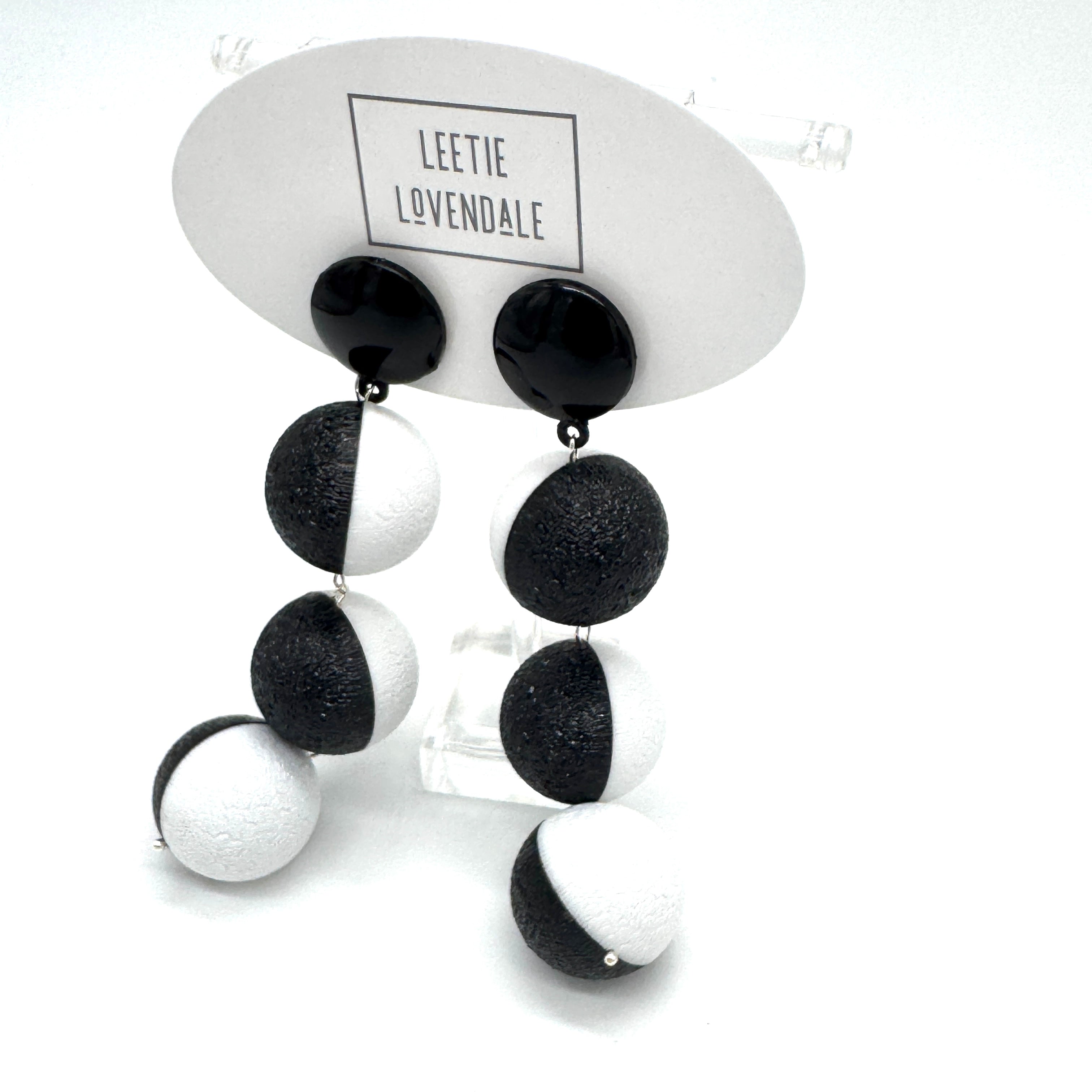 Black and white earrings on a Leetie Lovendale branded card