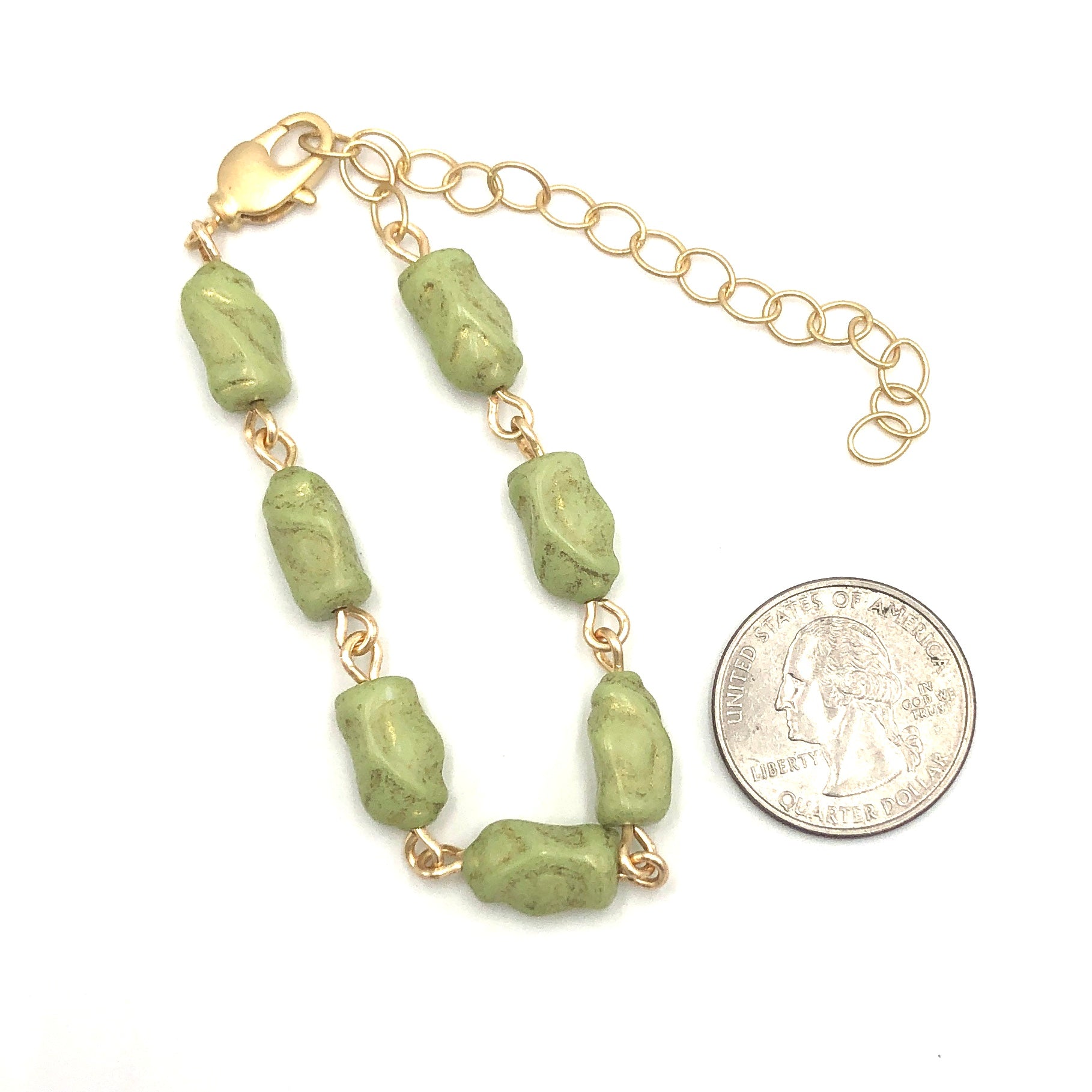green hand wired bracelet with quarter to show size