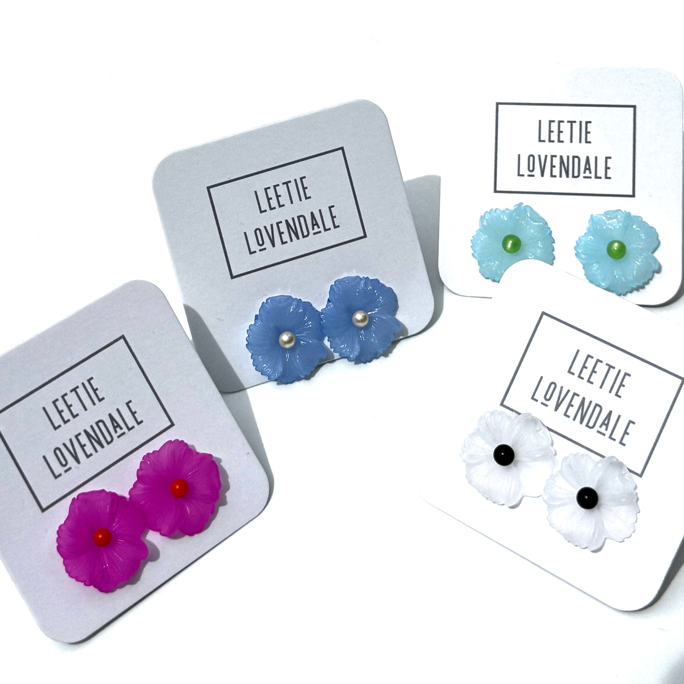 Set of floral earrings on display with &