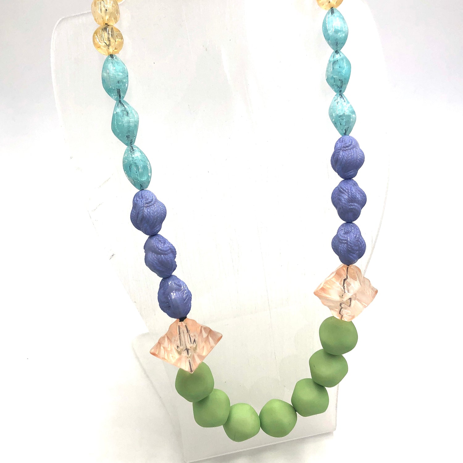 colorful stretch necklace on a stand