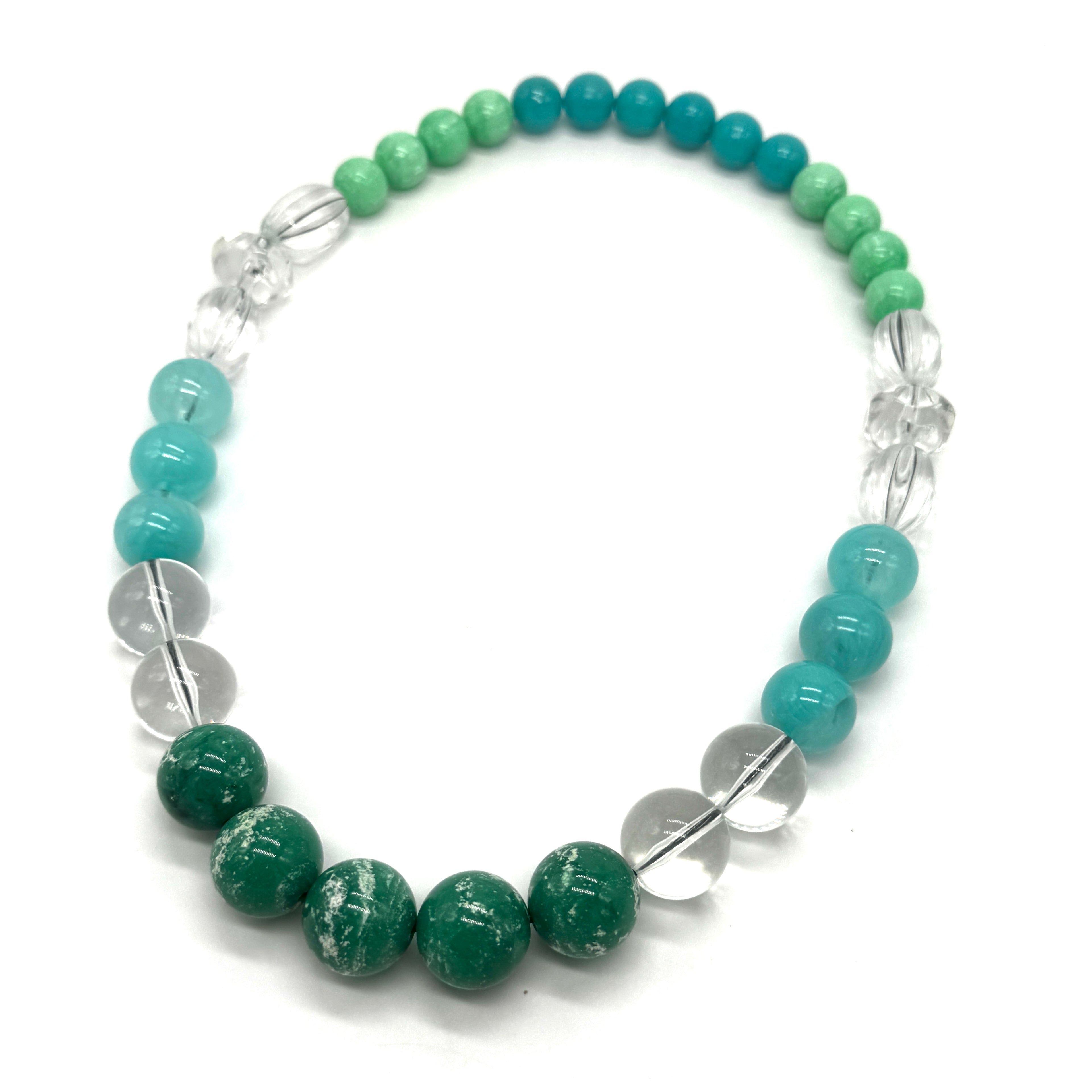 Necklace with green and blue beads on a white background