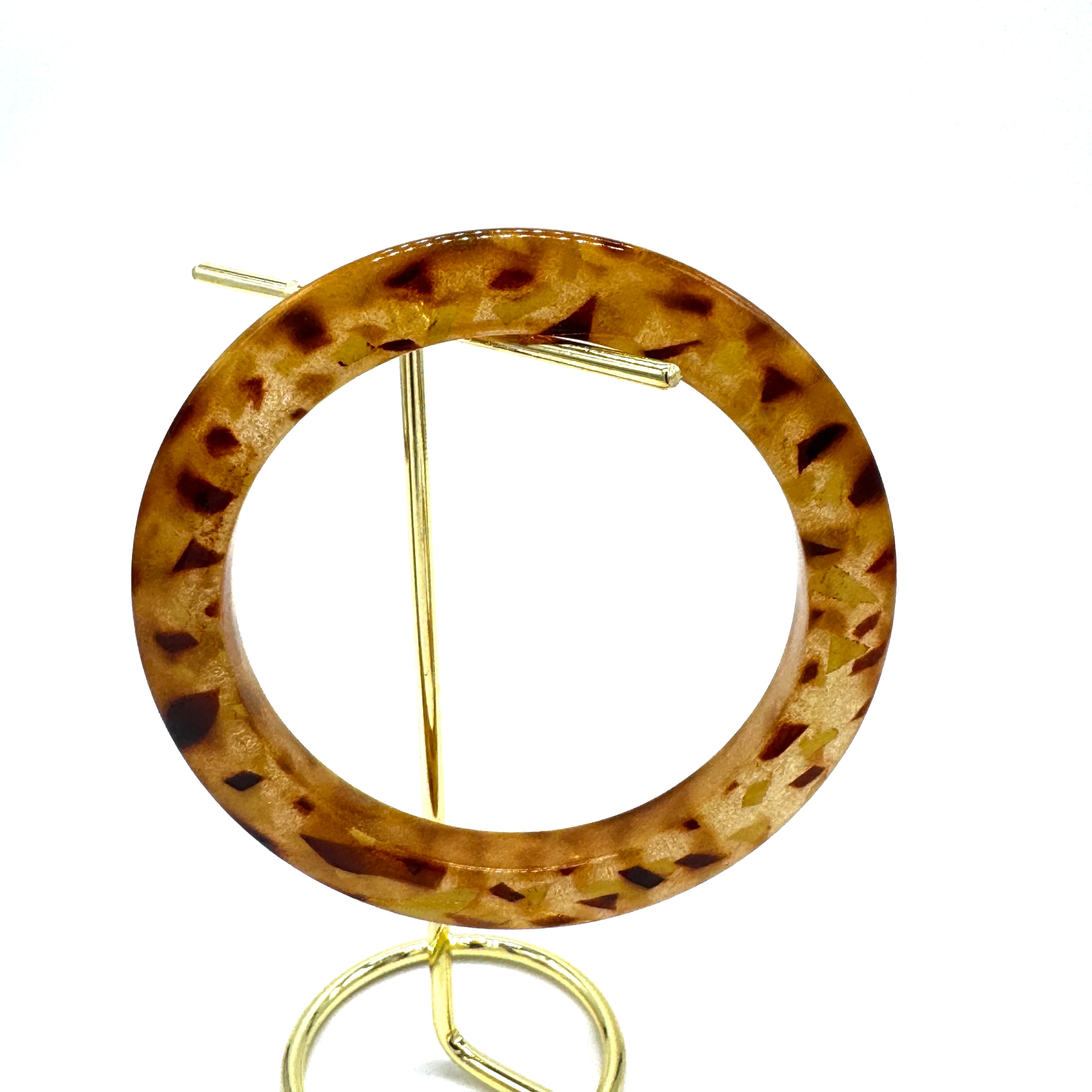 Round tortoiseshell bangle on a white background