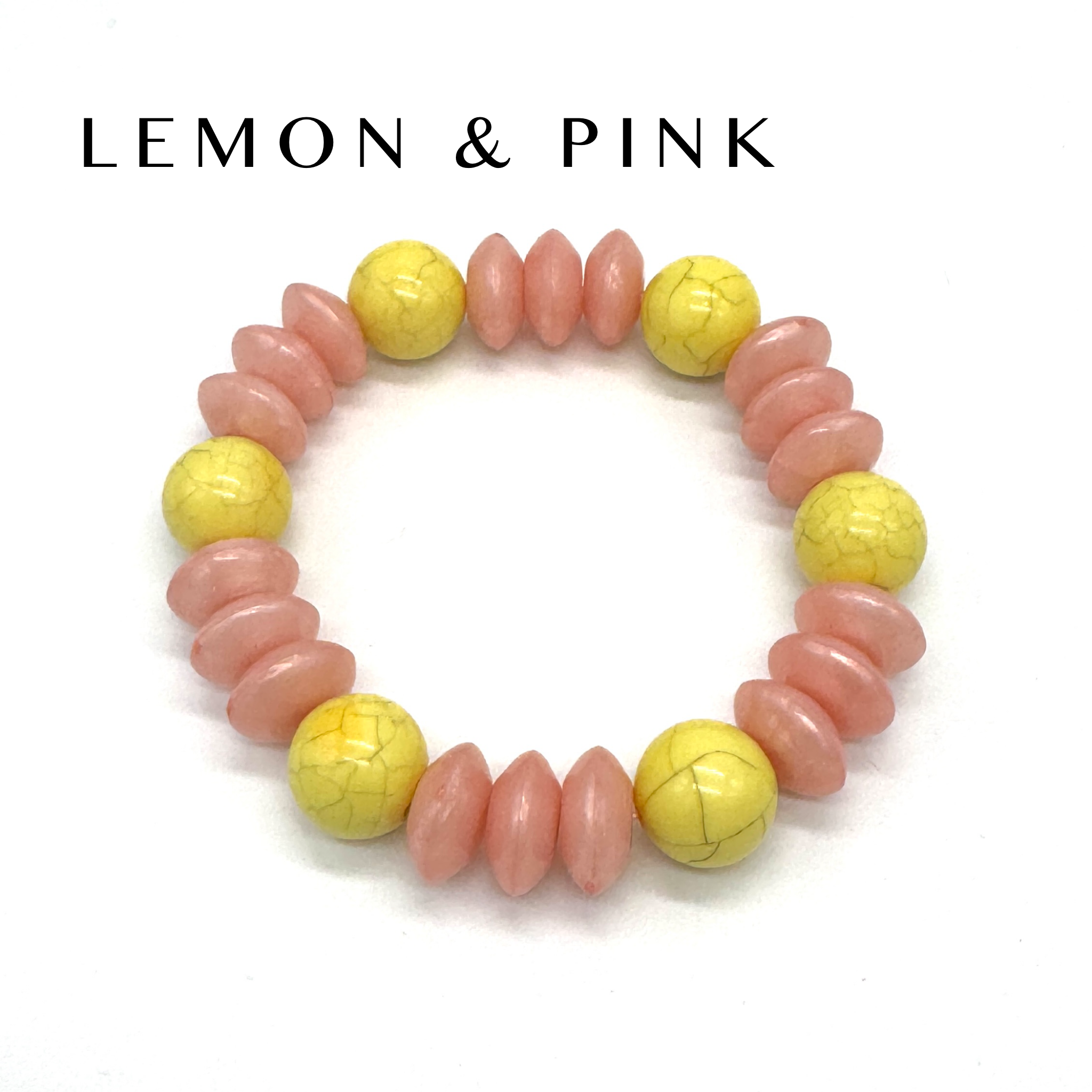Bracelet with pink and yellow beads on a white background, featuring &