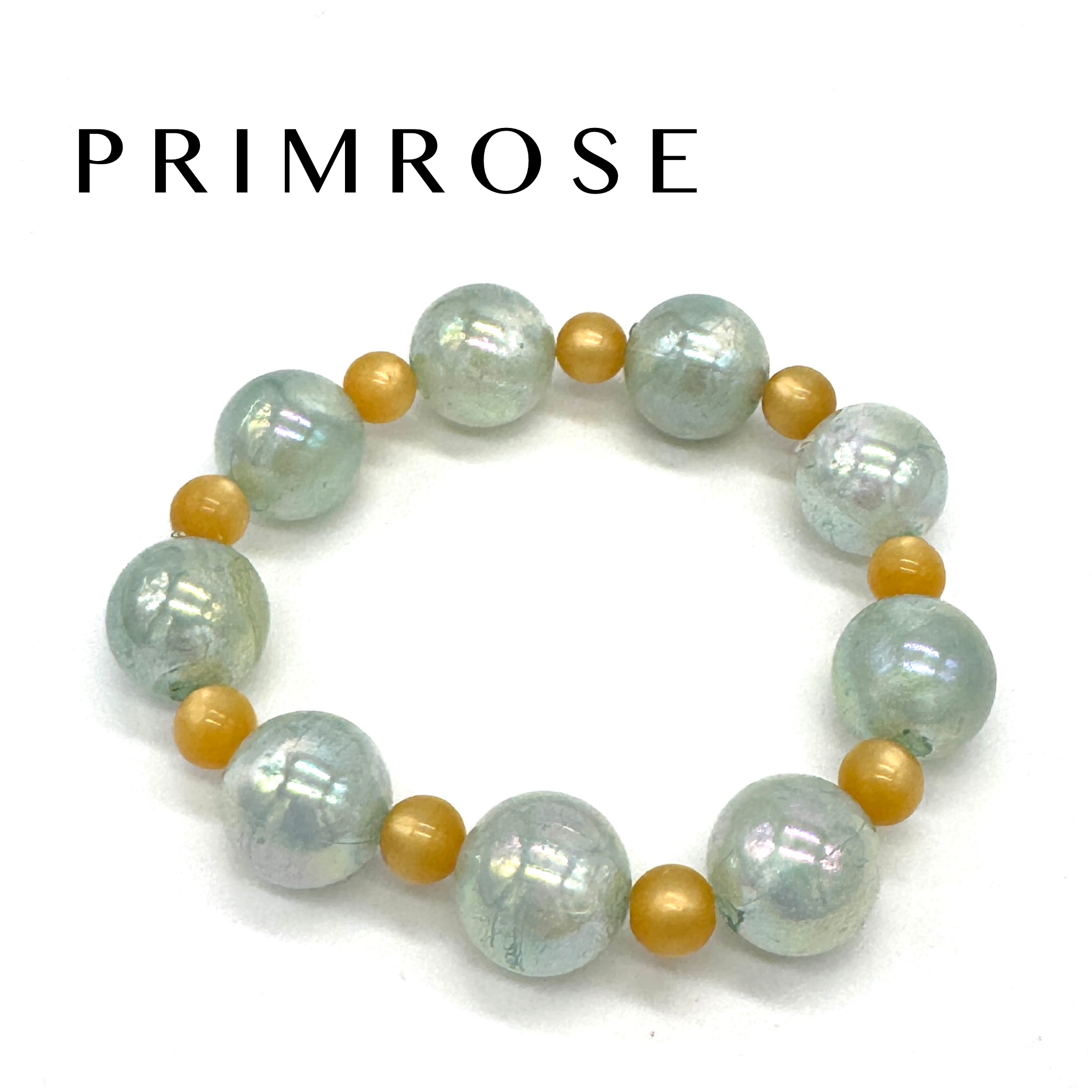 Beaded bracelet with white and gold beads on a white background, featuring the brand &