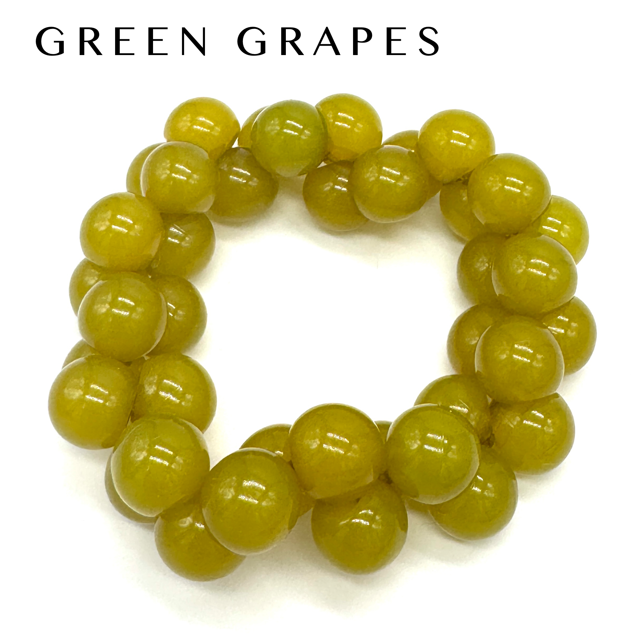 Green beaded bracelet on a white background with &
