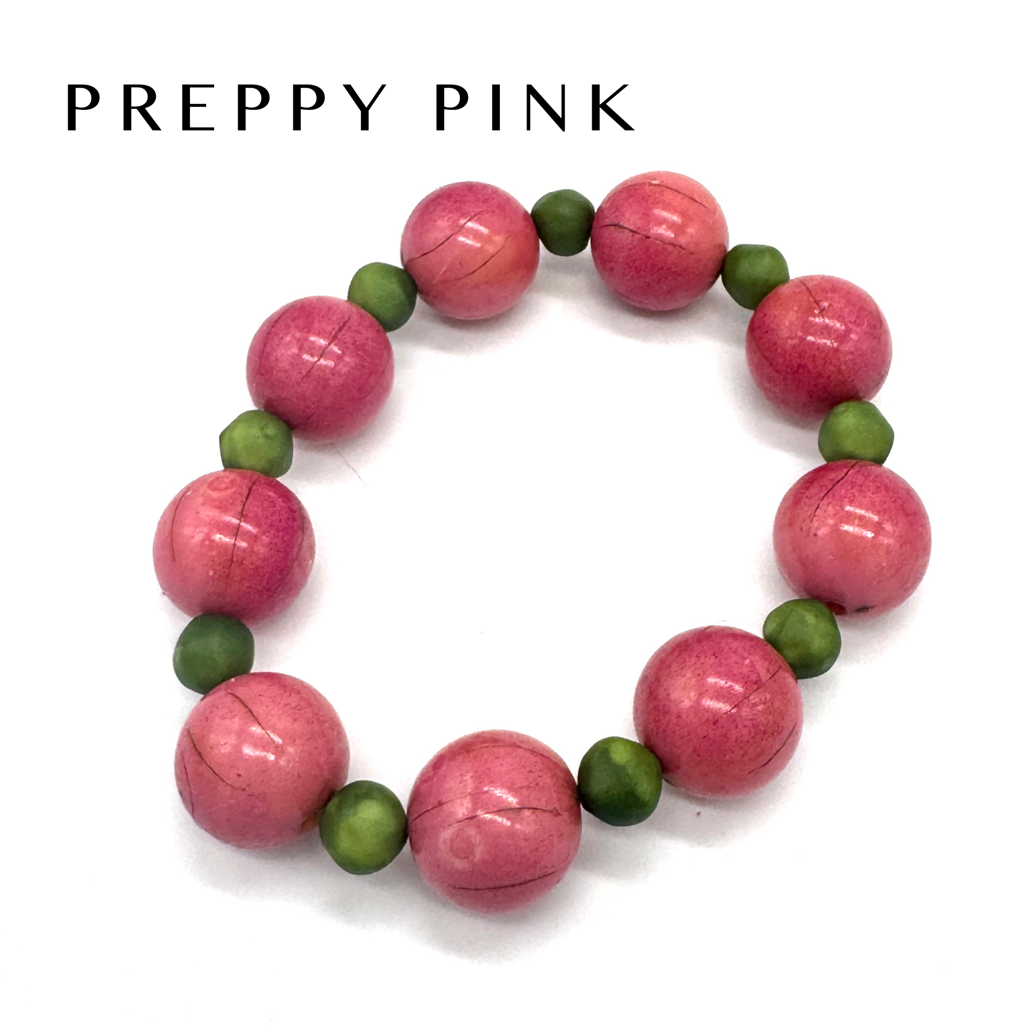 Bracelet with pink and green beads on a white background, labeled &