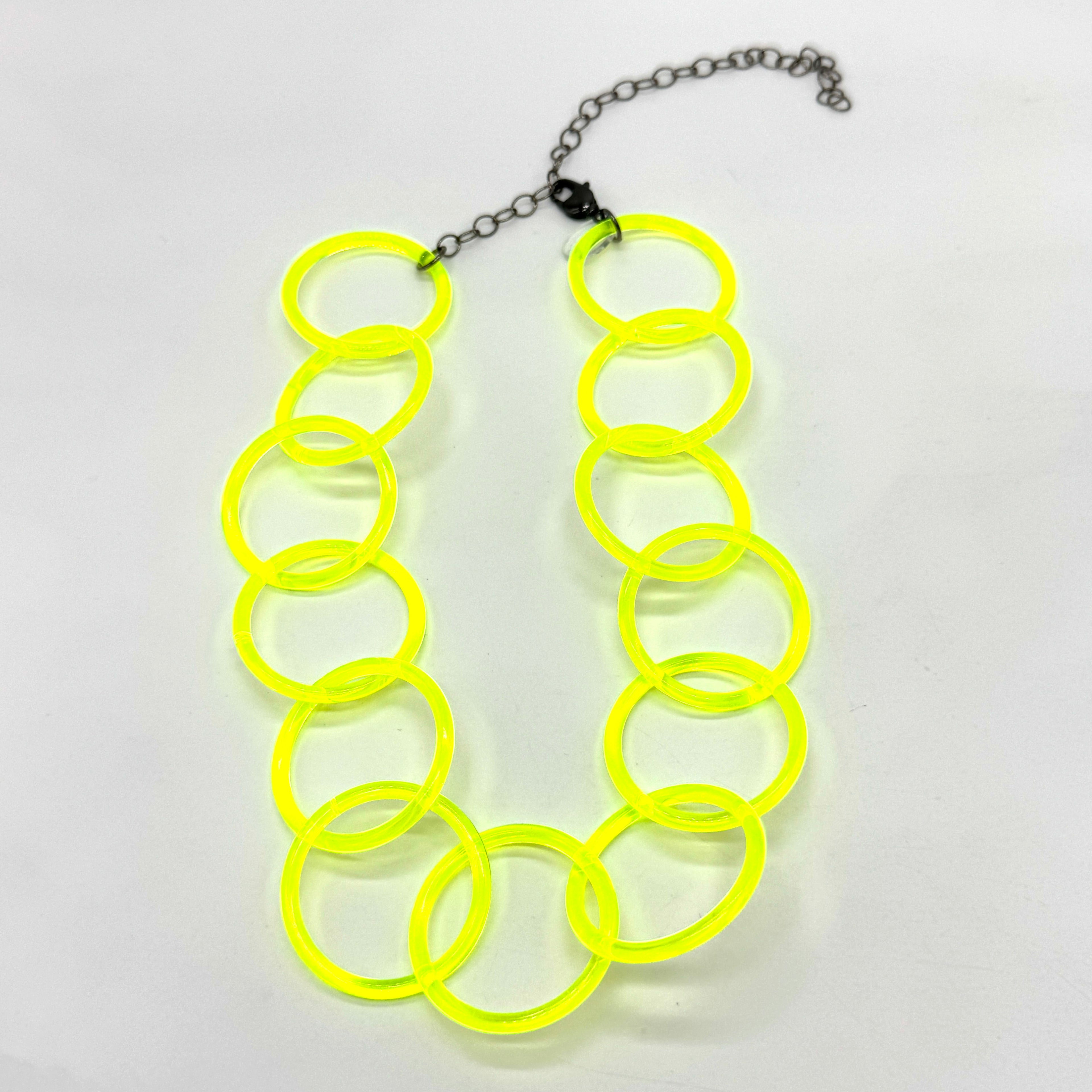 Adjustable necklace featuring large lucite chain links in a neon yellow