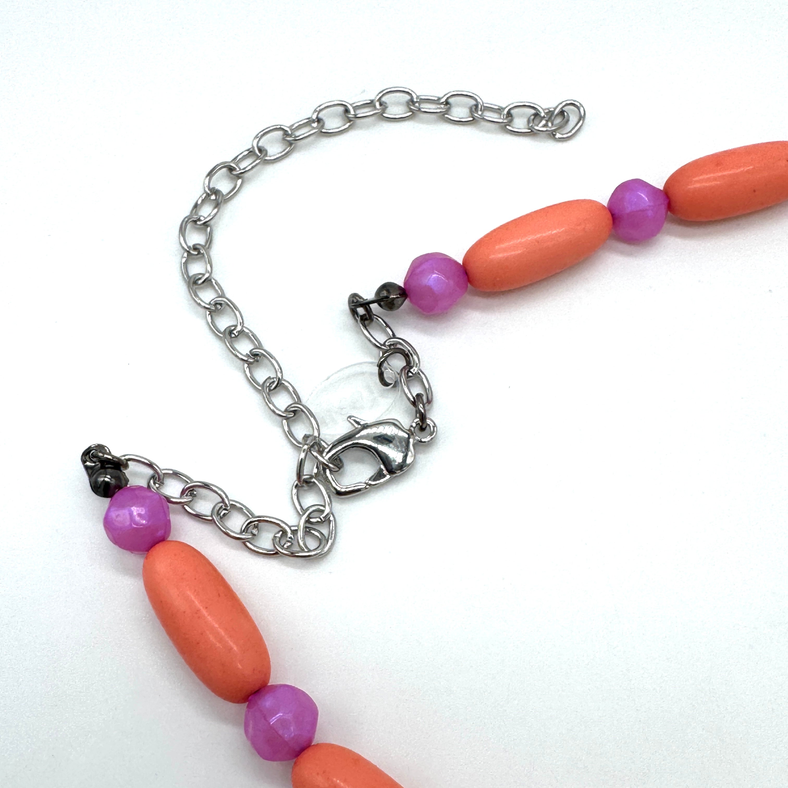Close up of bright coral and pink beaded necklace&