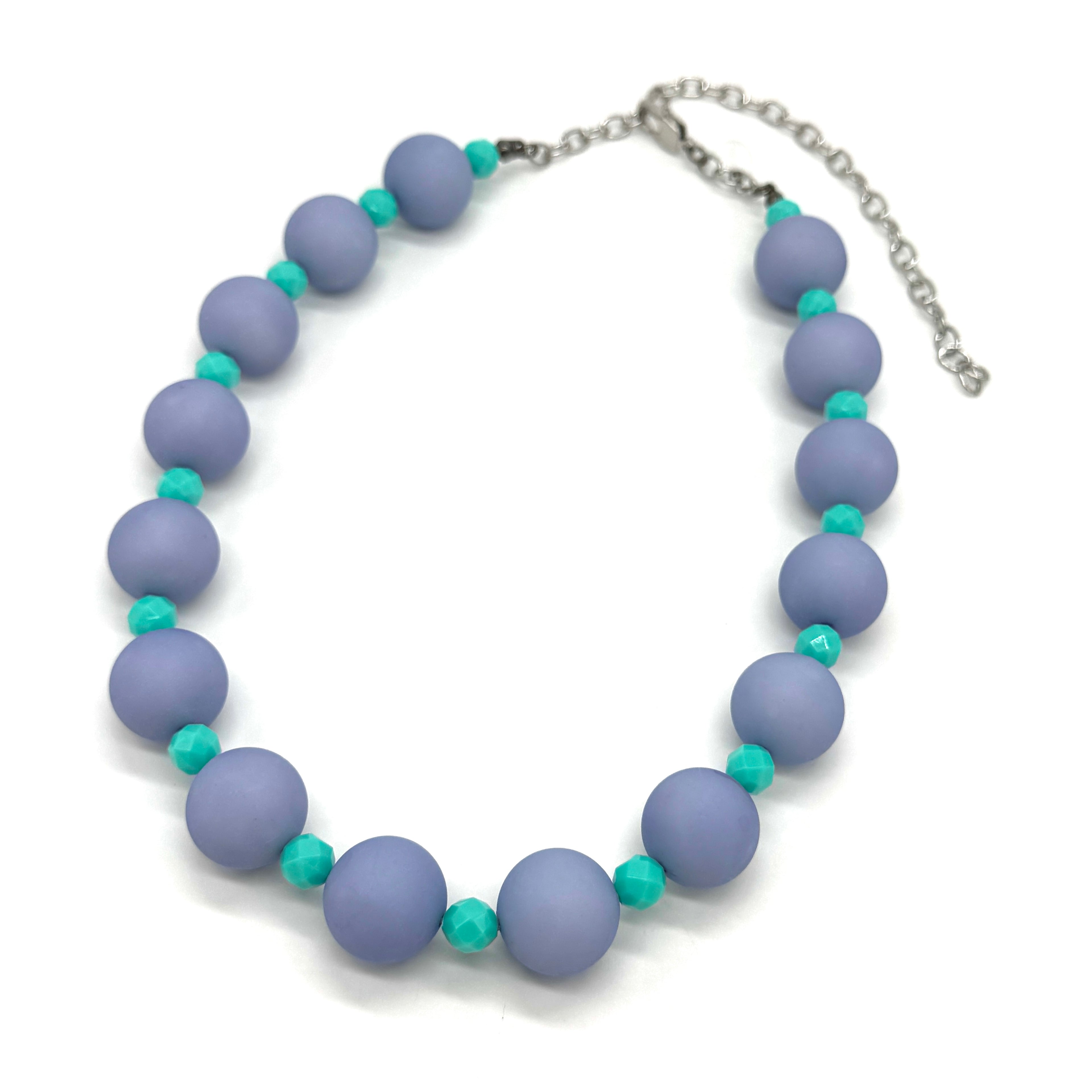 Adjustable necklace featuring chunky periwinkle lucite beads and smaller faceted turquoise spacers on a white background.
