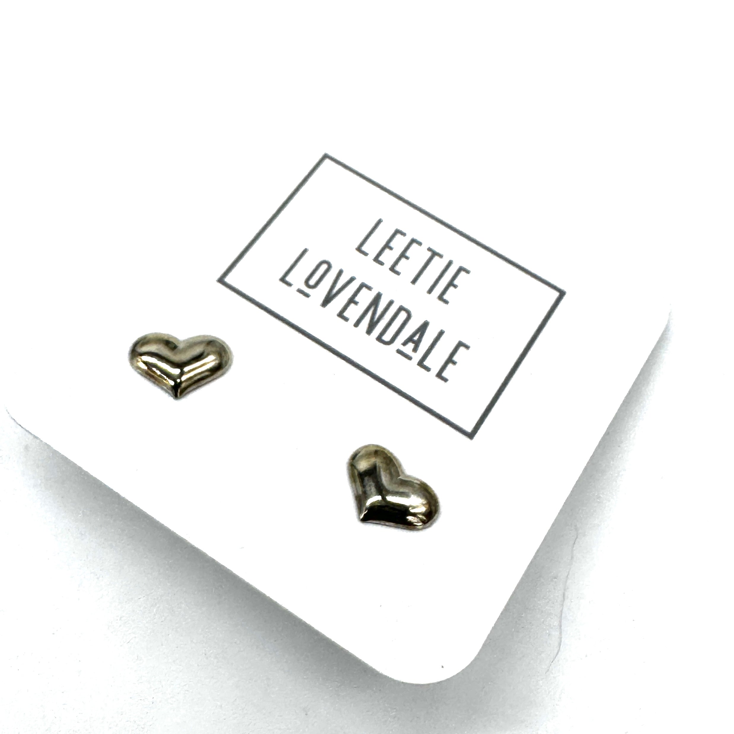 Heart-shaped earrings on a card with &