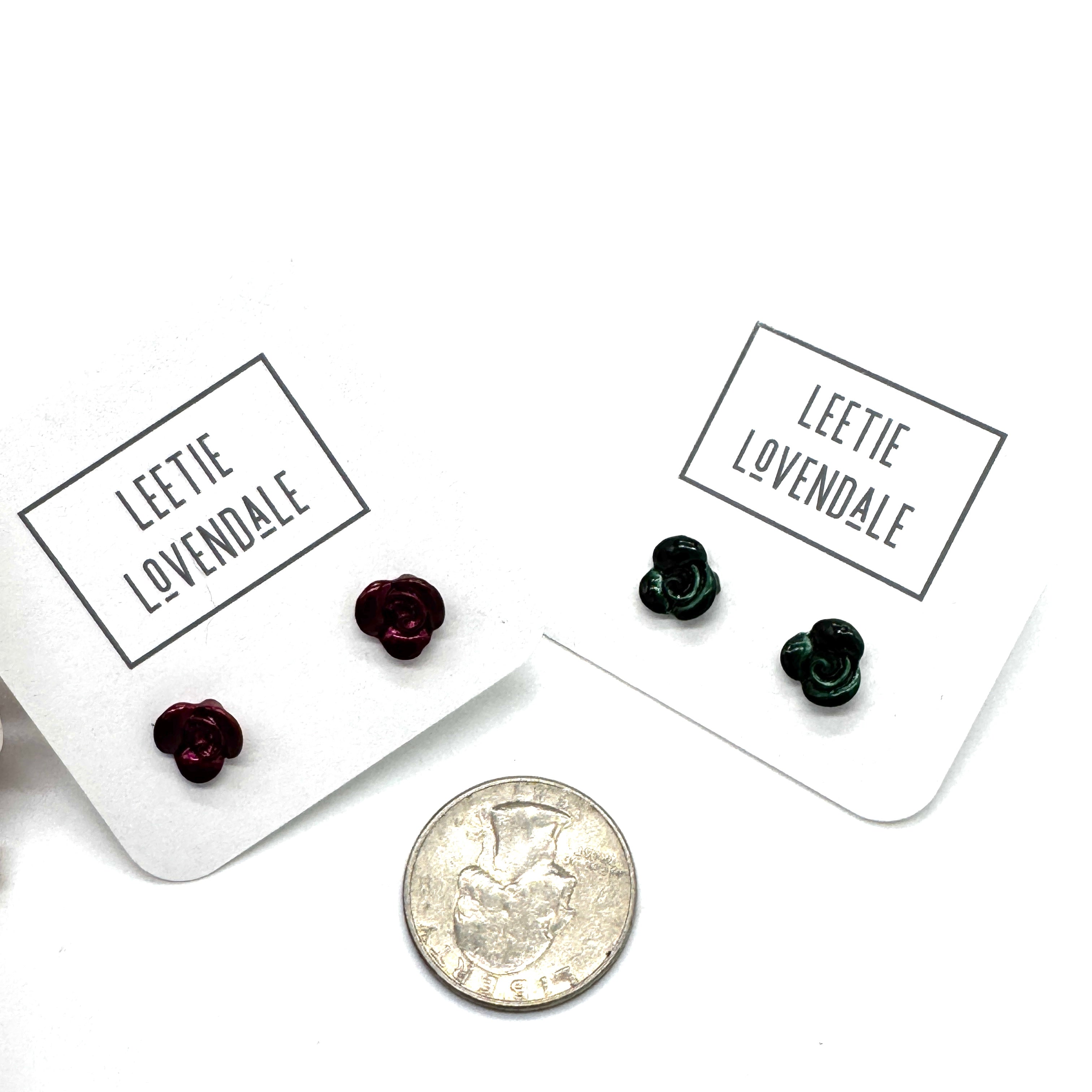 Two pairs of earrings on cards with &