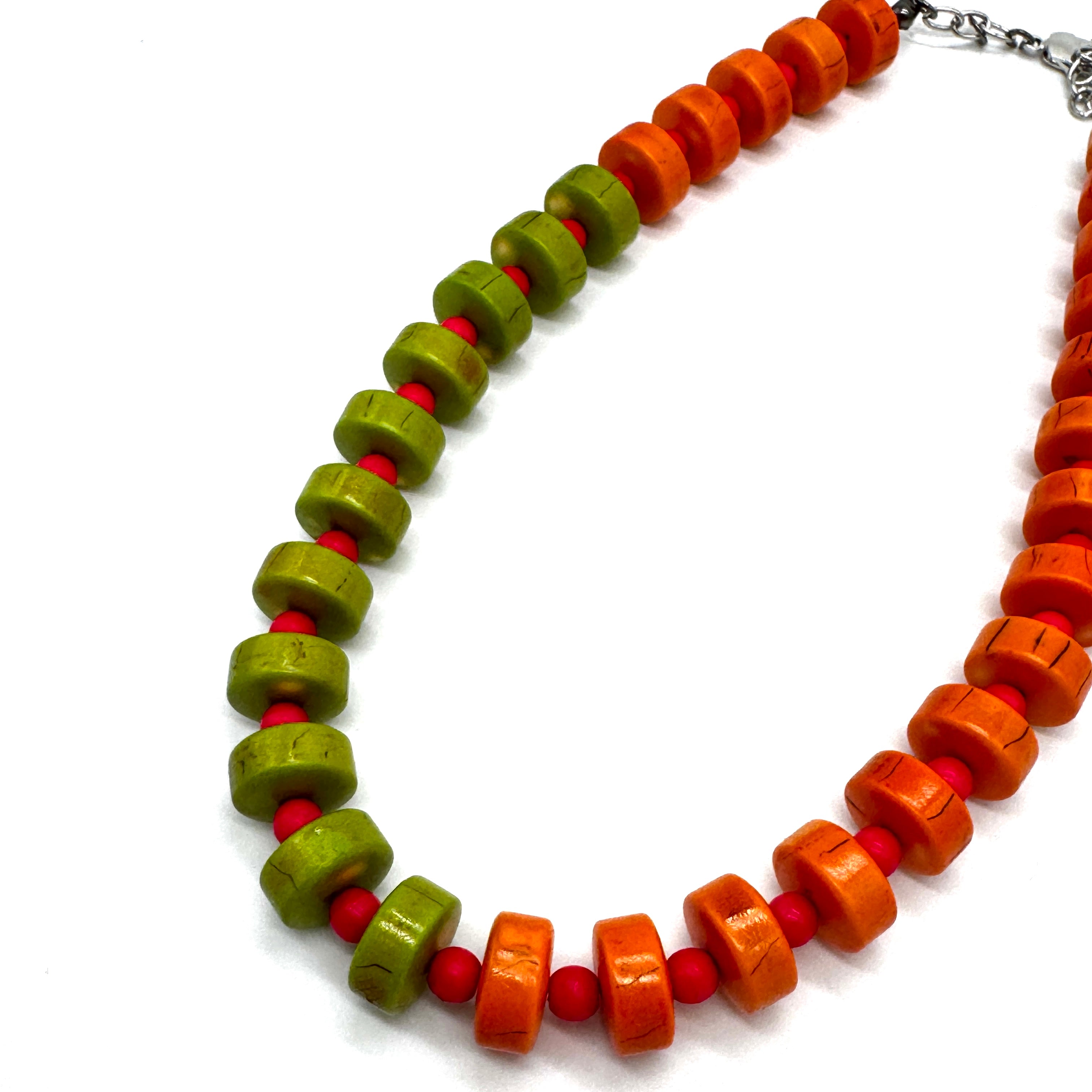 Necklace with orange, green, and red beads on a white background