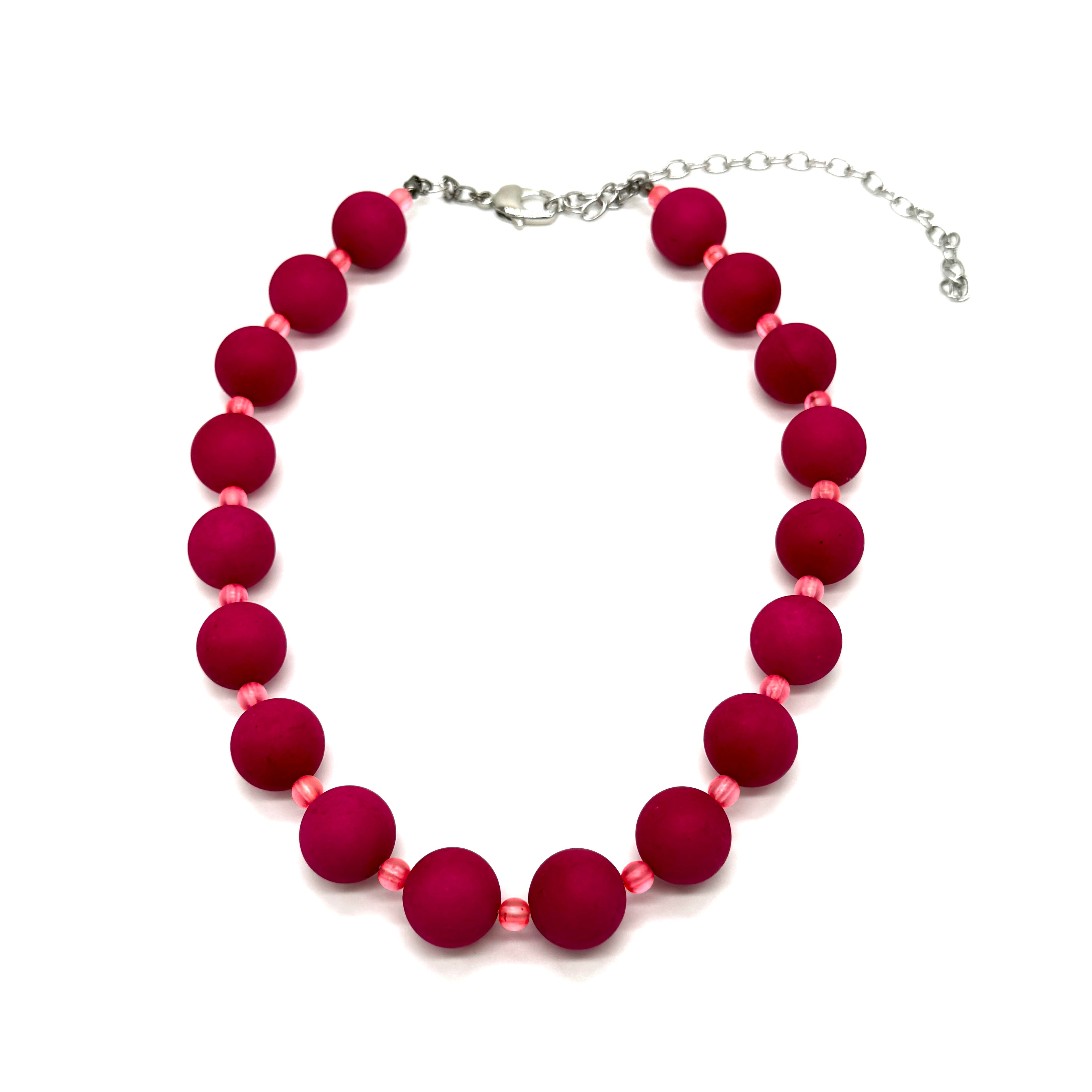 Necklace with red beads on a white background