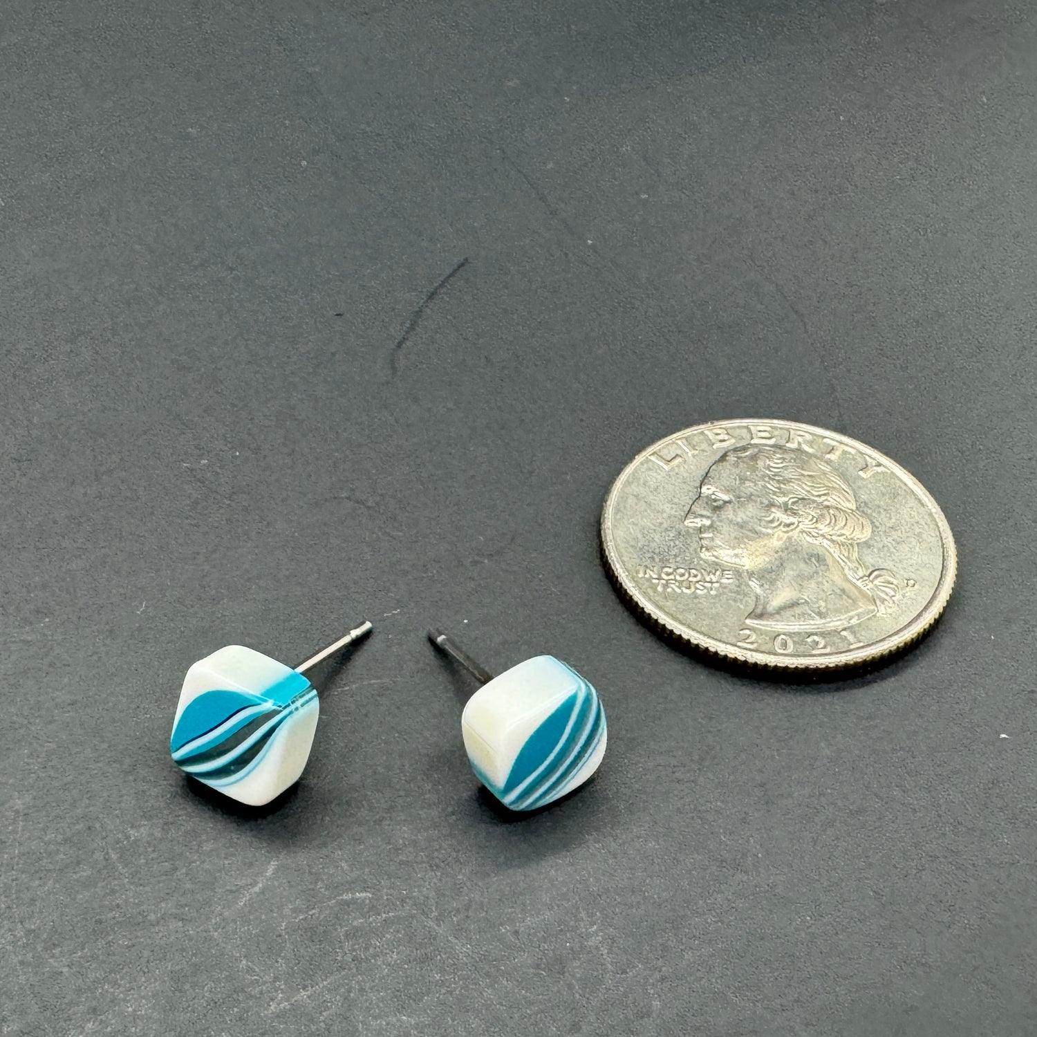 best plastics vintage blue stripe stud earrings next to quarter for size reference