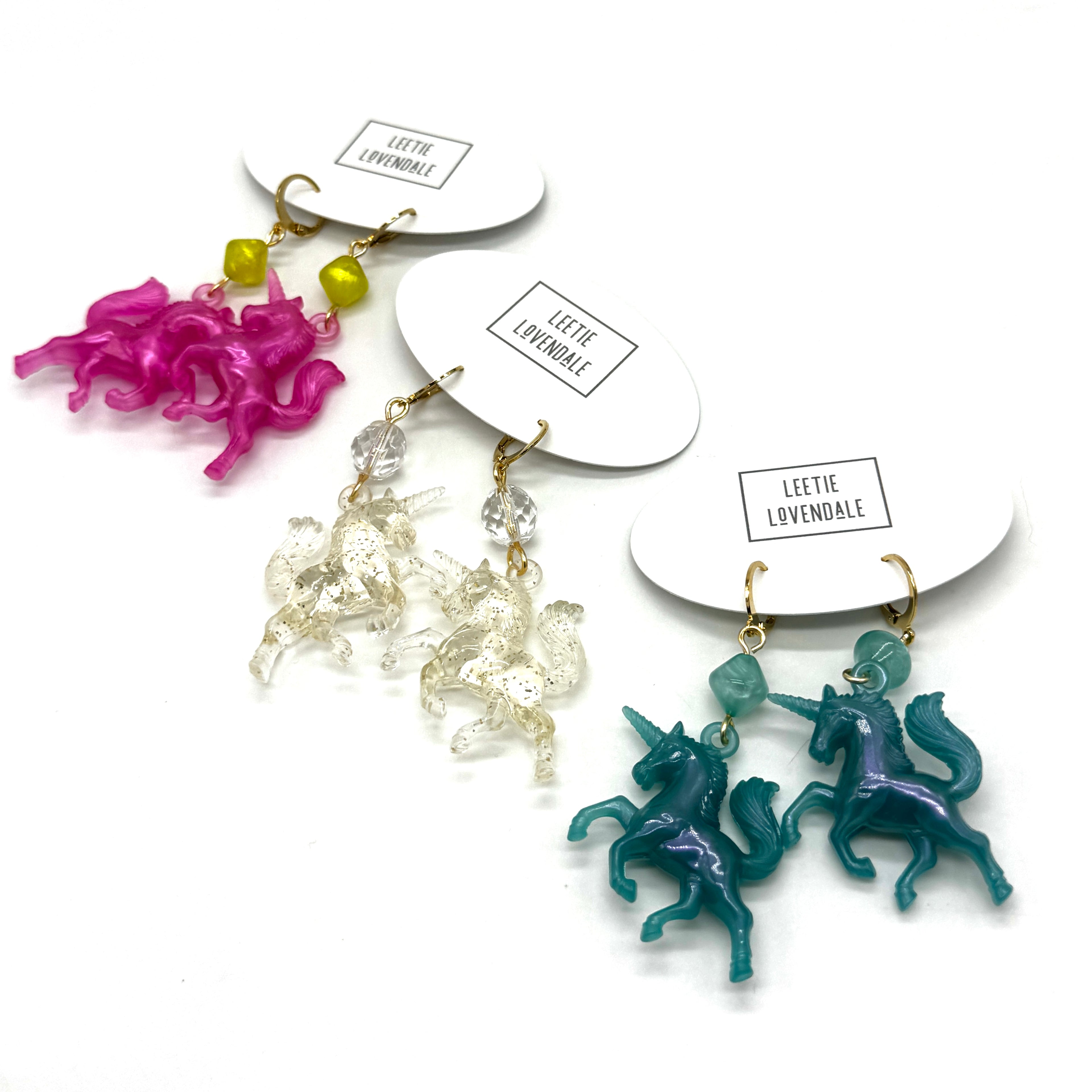 Unicorn-shaped earrings on display with &