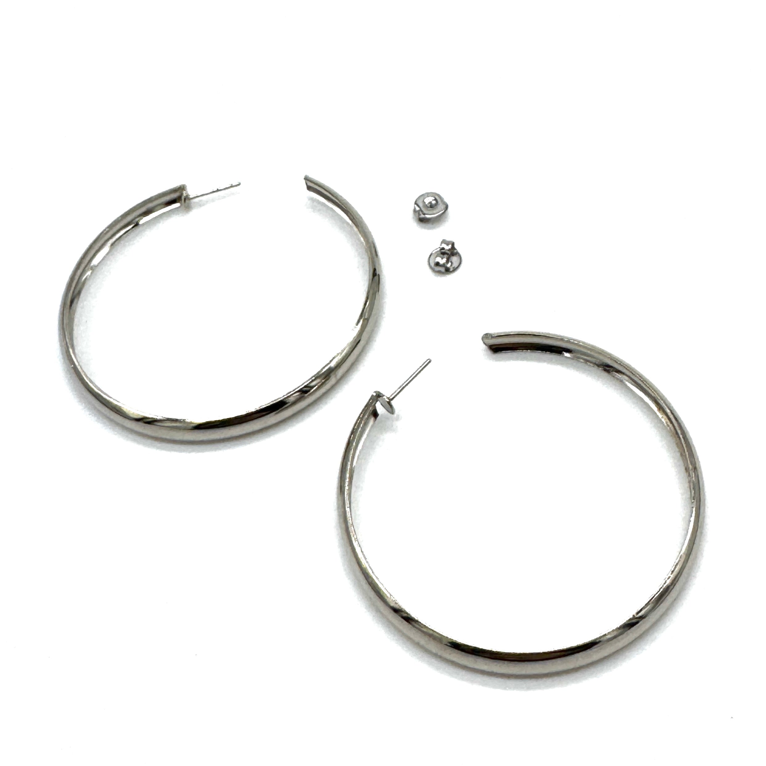 Large silver hoop earrings on a white background.