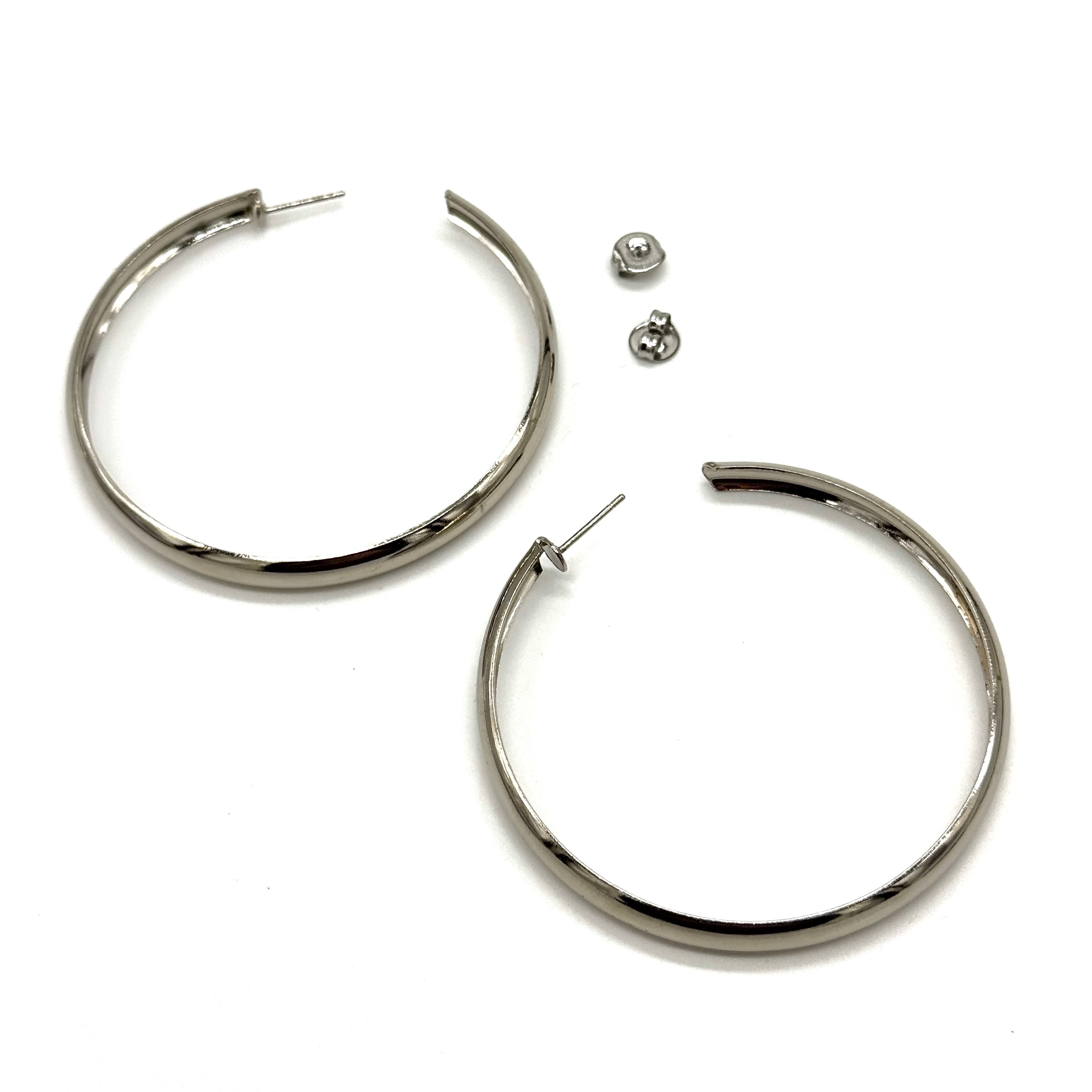 Large silver hoop earrings on a white background.