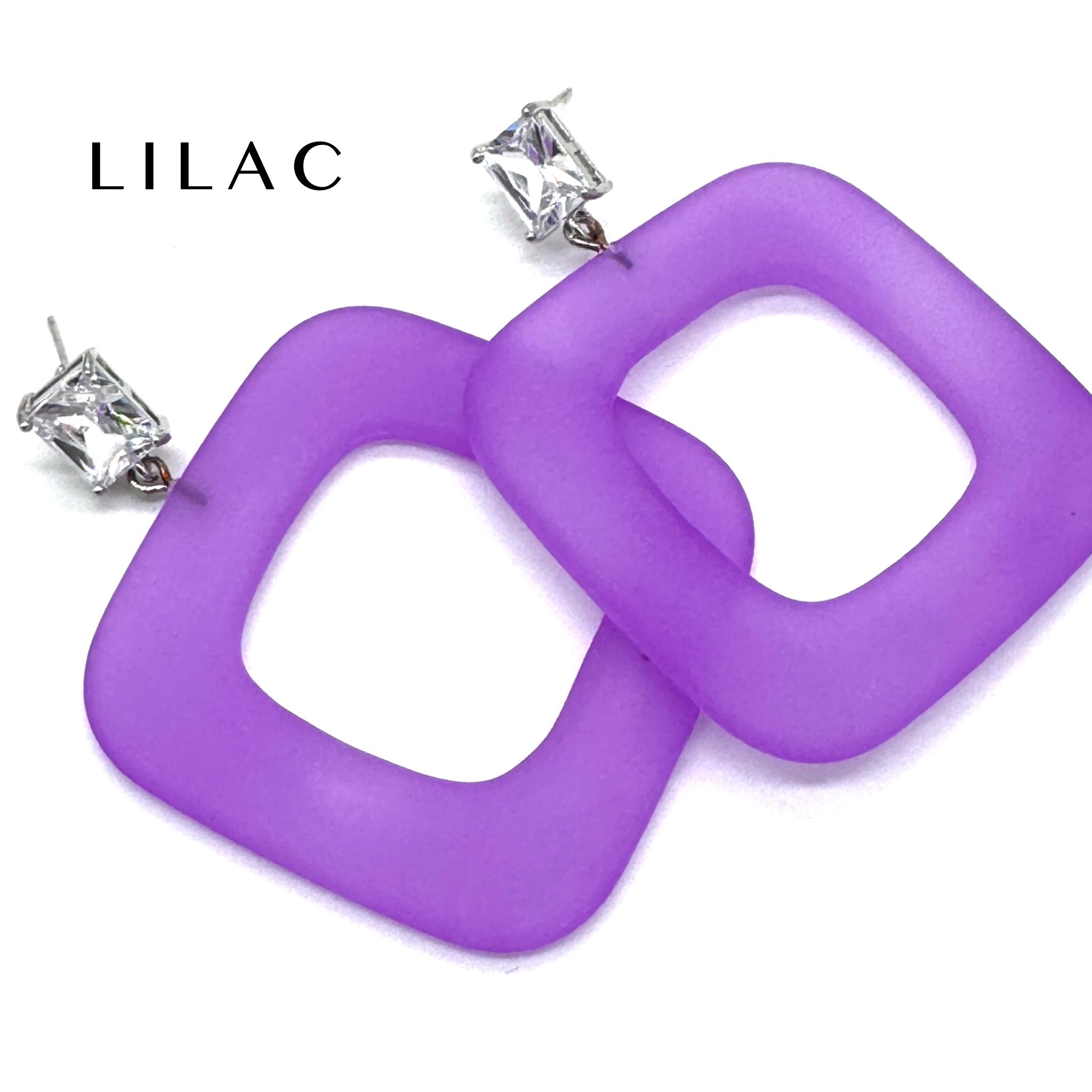 Purple square ring dangle earrings with silver post backs and clear rhinestones, shown on a white background with the brand name &