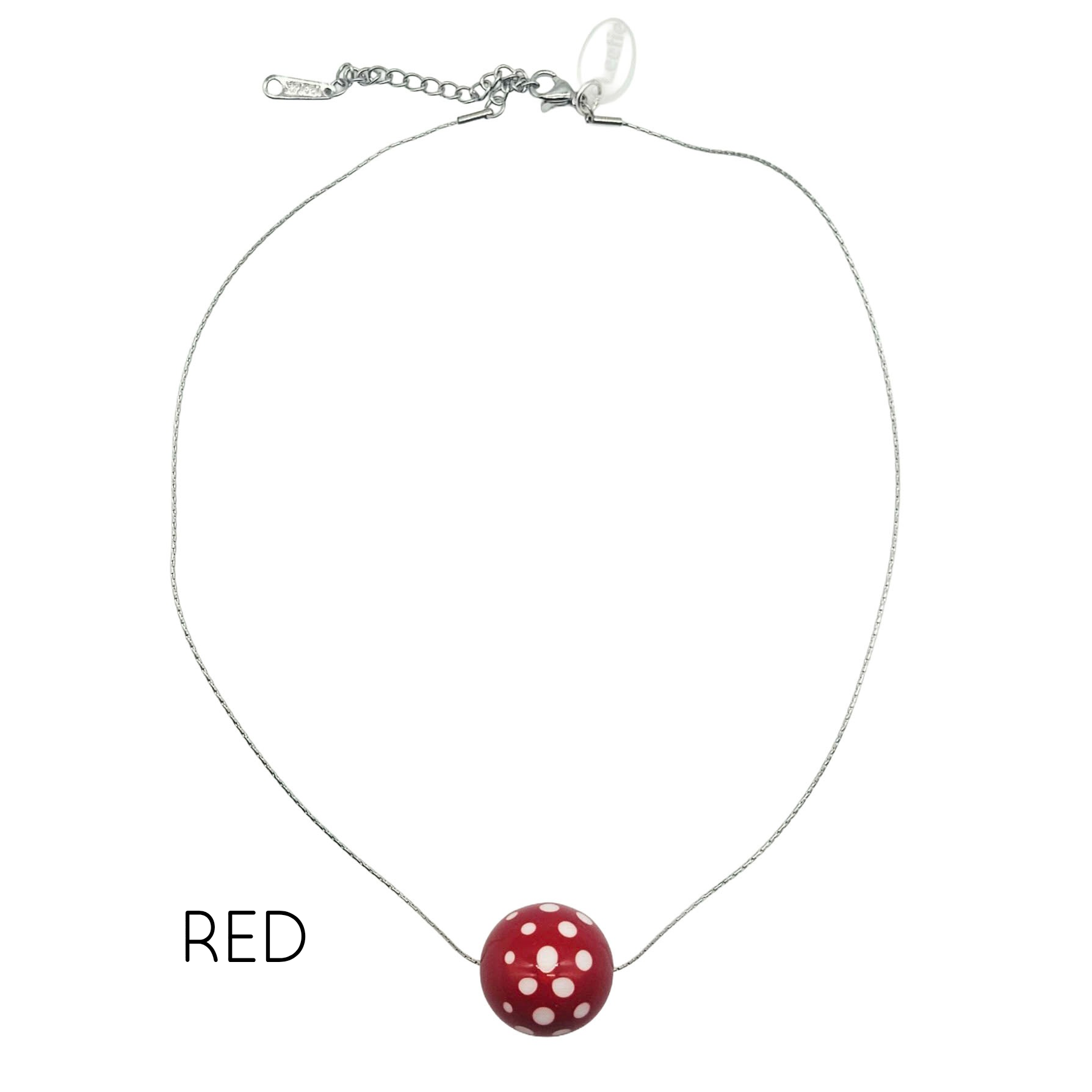 Necklace with a red and white polka dot pendant on a white background