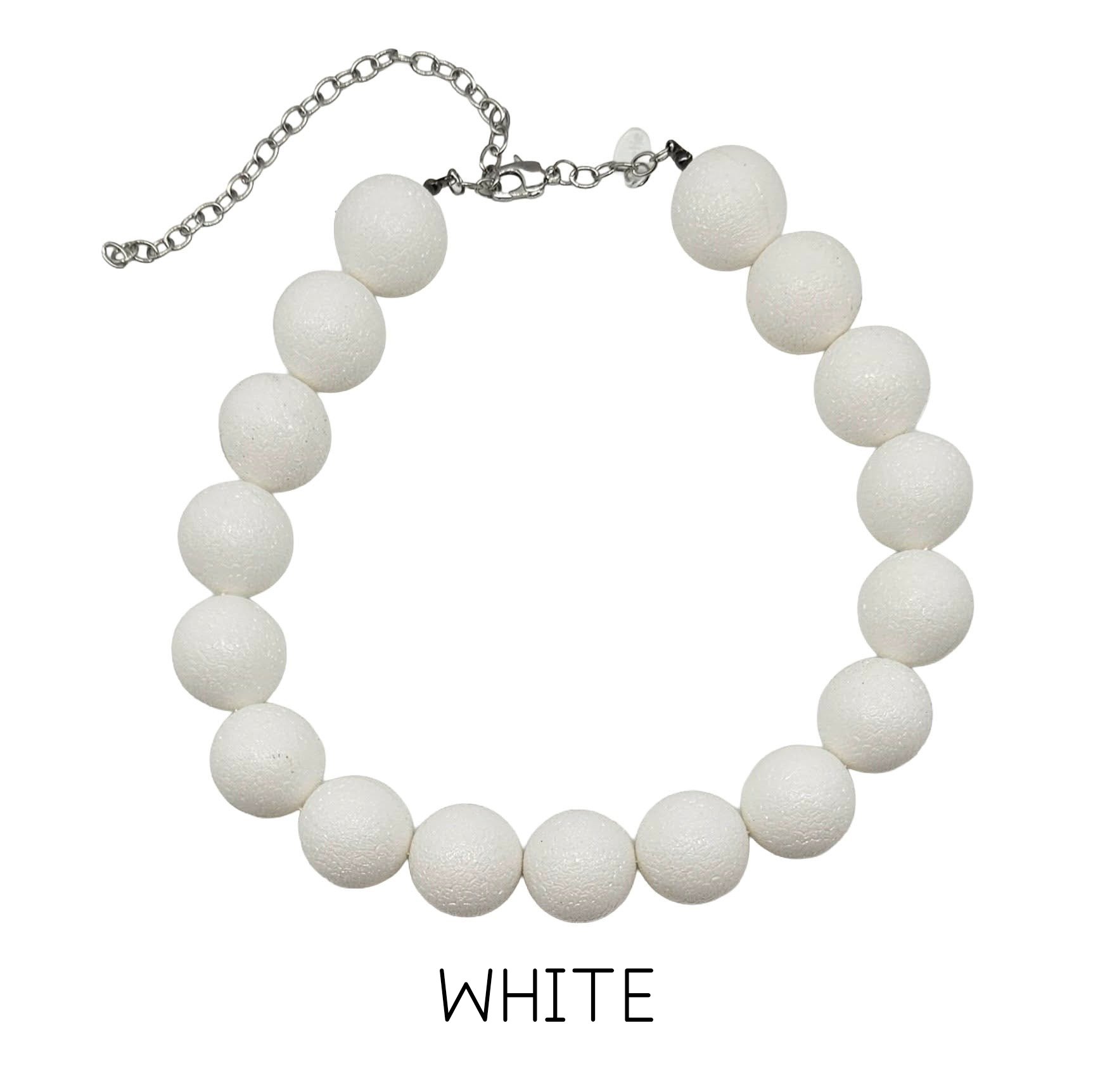 White beaded necklace on a white background with &