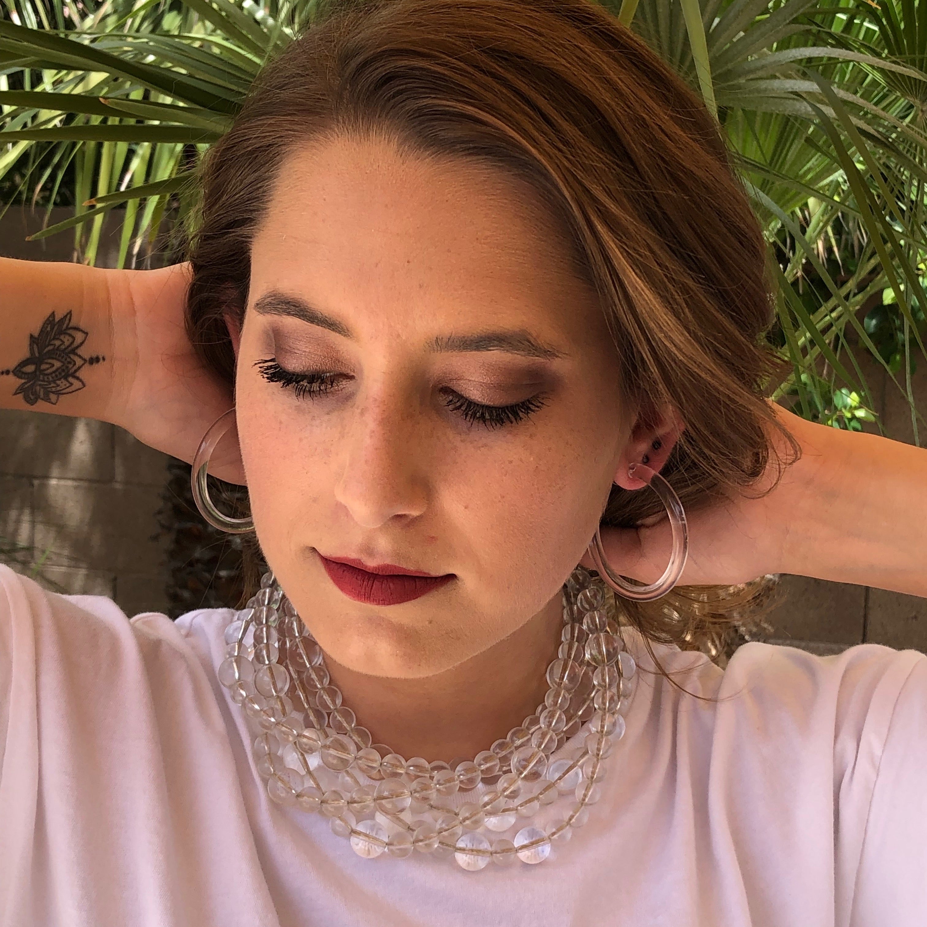 clear lucite jewelry on woman