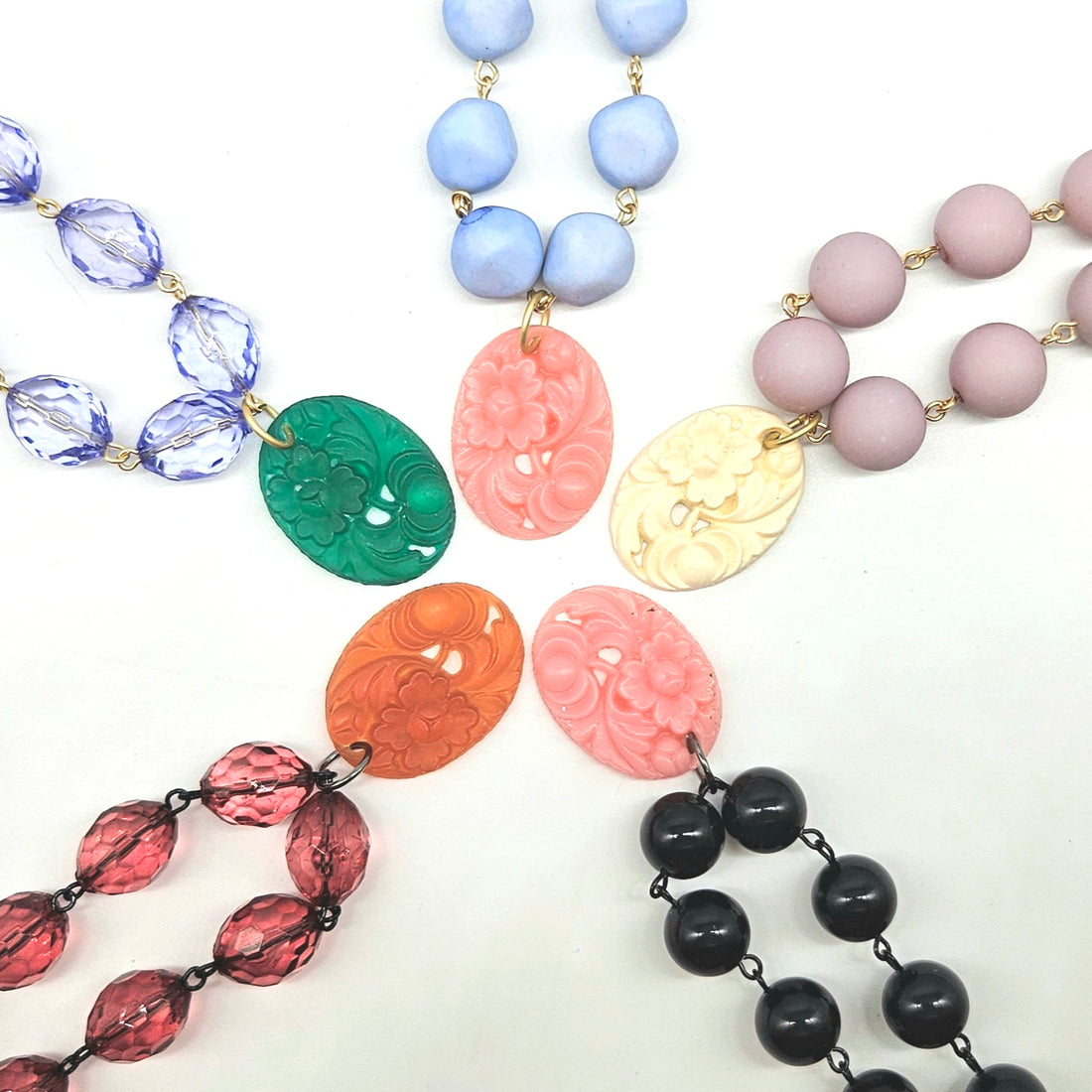 Collection of colorful beaded necklaces on a white background