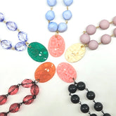 Collection of colorful beaded necklaces on a white background