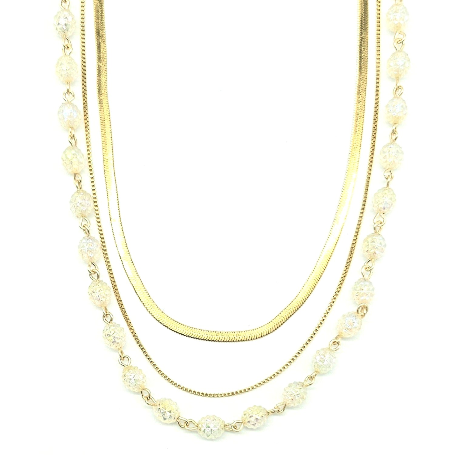 Three-strand necklace with gold chains and clear-colored beads on a white background