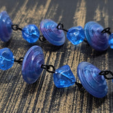 Close up of blue and purple lucite beaded necklace textured surface