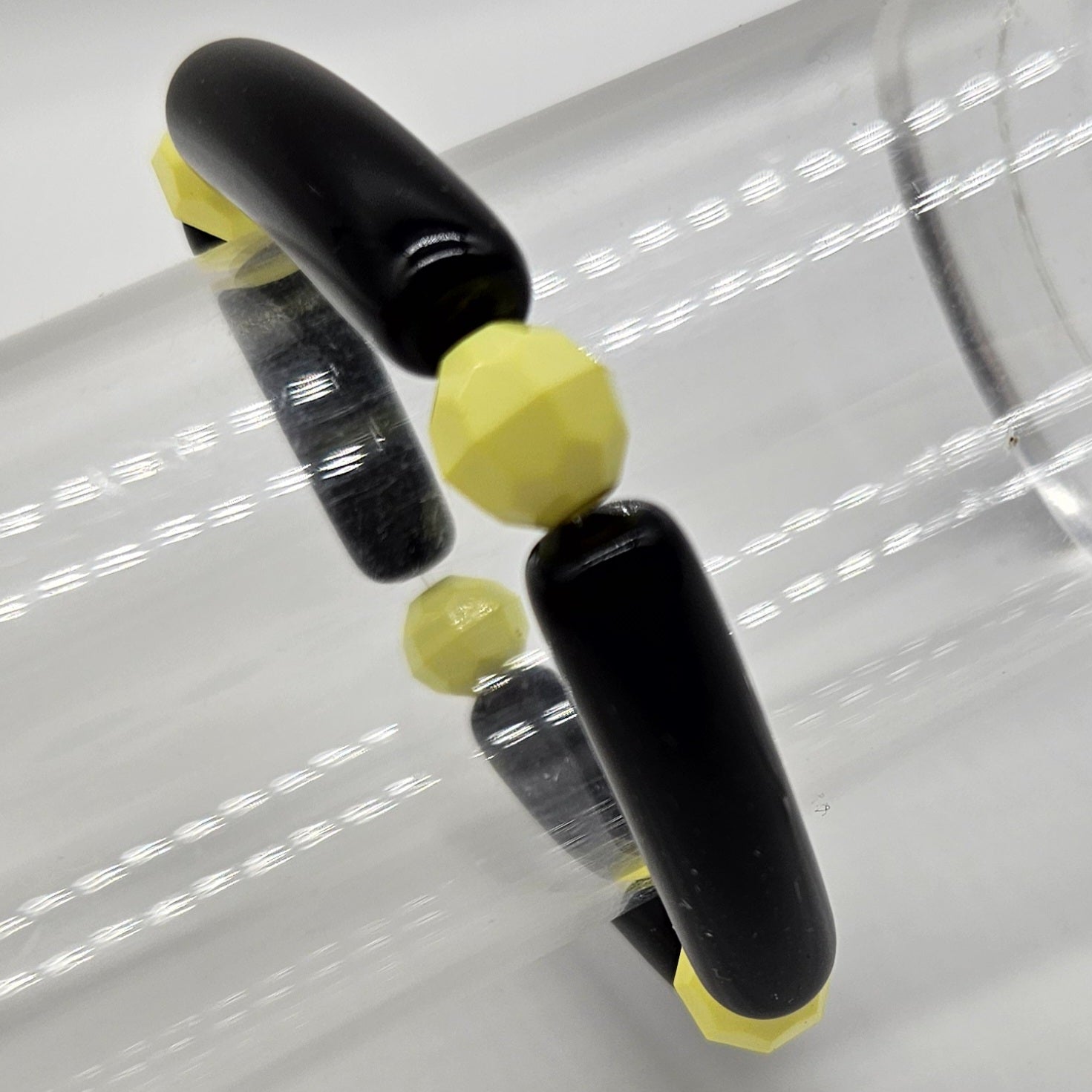 Black and yellow bracelet on a white background