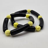 Black and yellow beaded bracelets on a white background