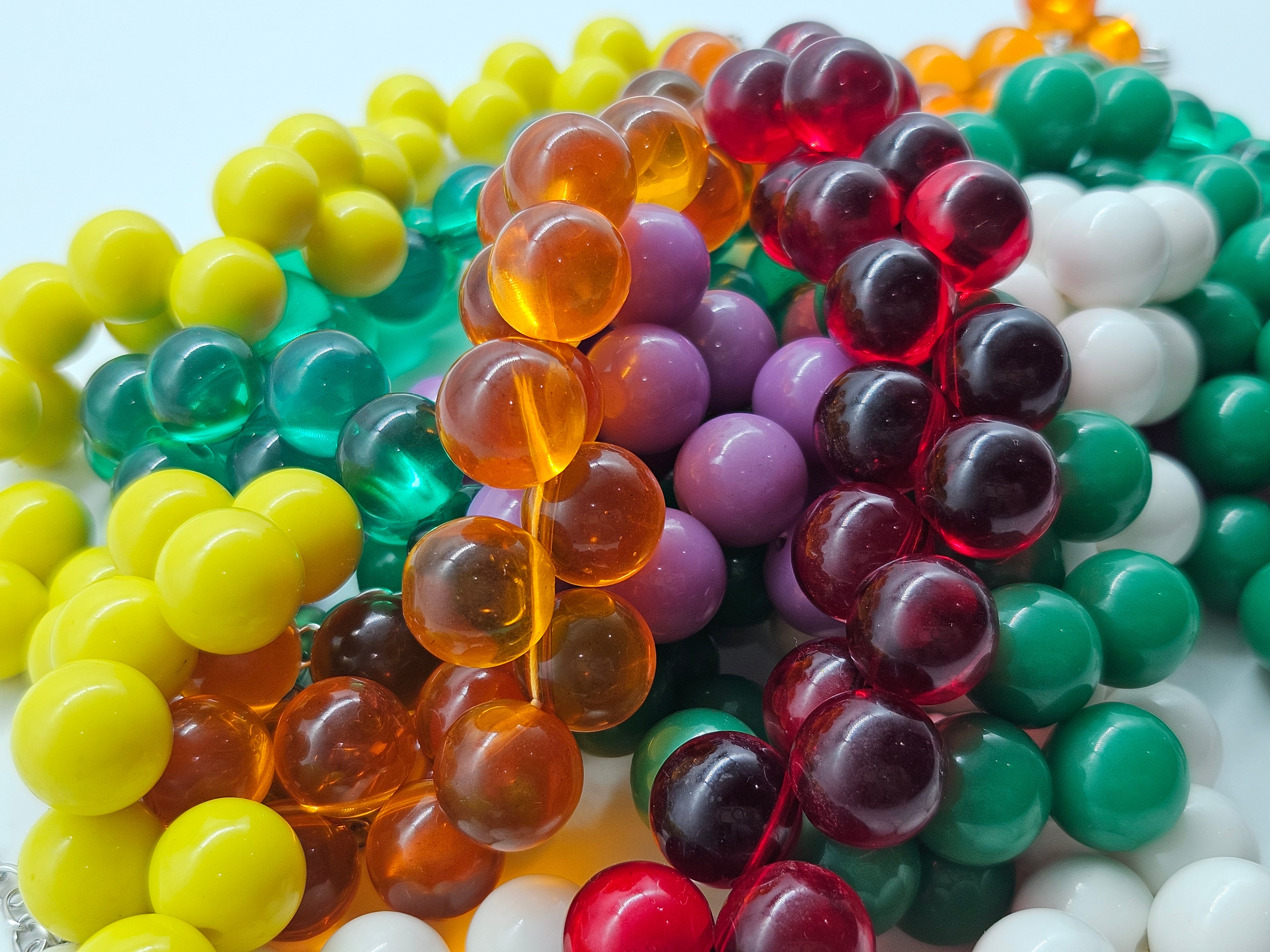 A jumble of several colorful beaded necklaces.