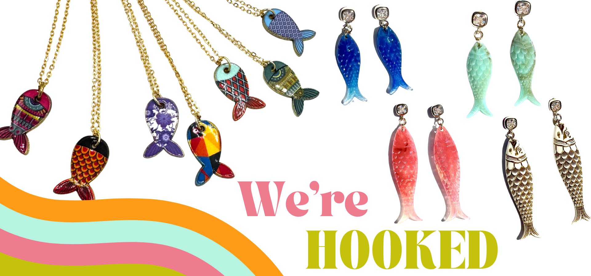 A promotional graphic showing multiple fish-shaped jewelry pieces on a white background with a colorful wave graphic at the bottom left and the text 'We're HOOKED'. The products include several necklaces with gold-tone chains and fish pendants in blue, green, purple, orange, and multicolor patterns, alongside matching fish earrings in blue, green, pink, and gold-tone finishes.