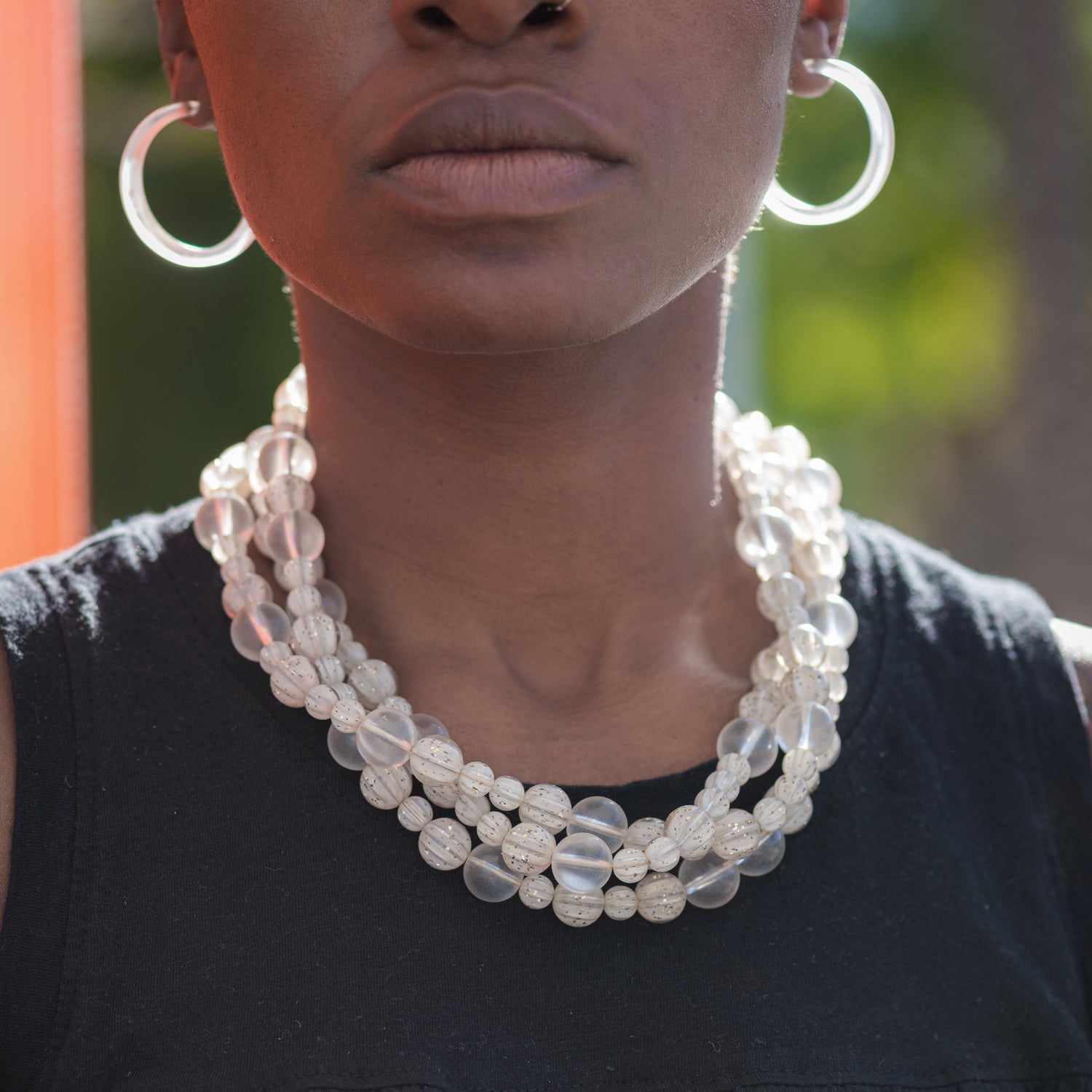 clear frosted statement necklace and earrings on model