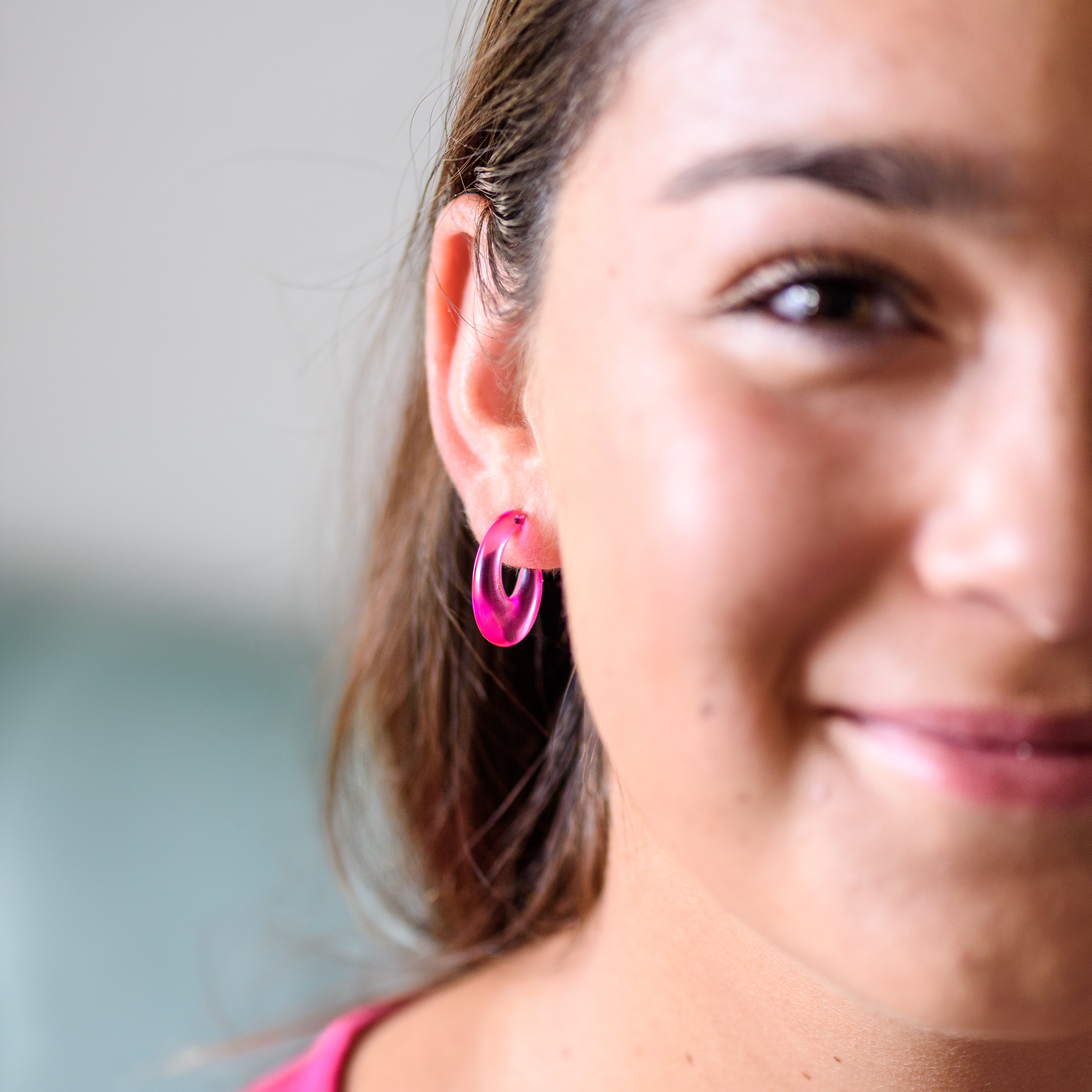 frisco hoop earrings in hot pink on a model