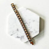 Bracelet with brown stones on a marble surface