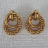 Pair of gold hoop earrings on a textured gray background