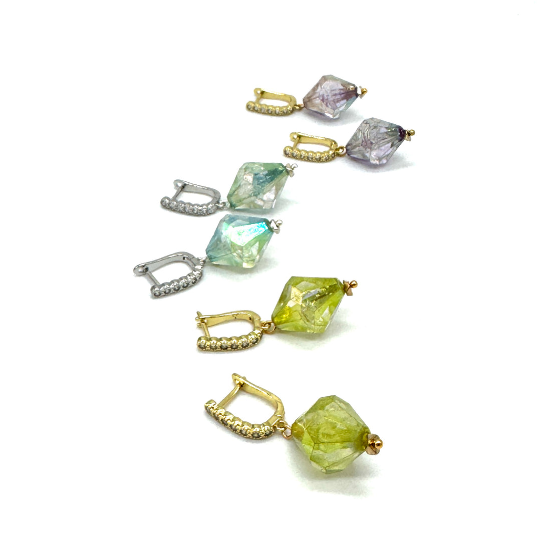 Set of colorful gemstone earrings on a white background