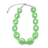 Necklace with green beads and blue accents on a white background