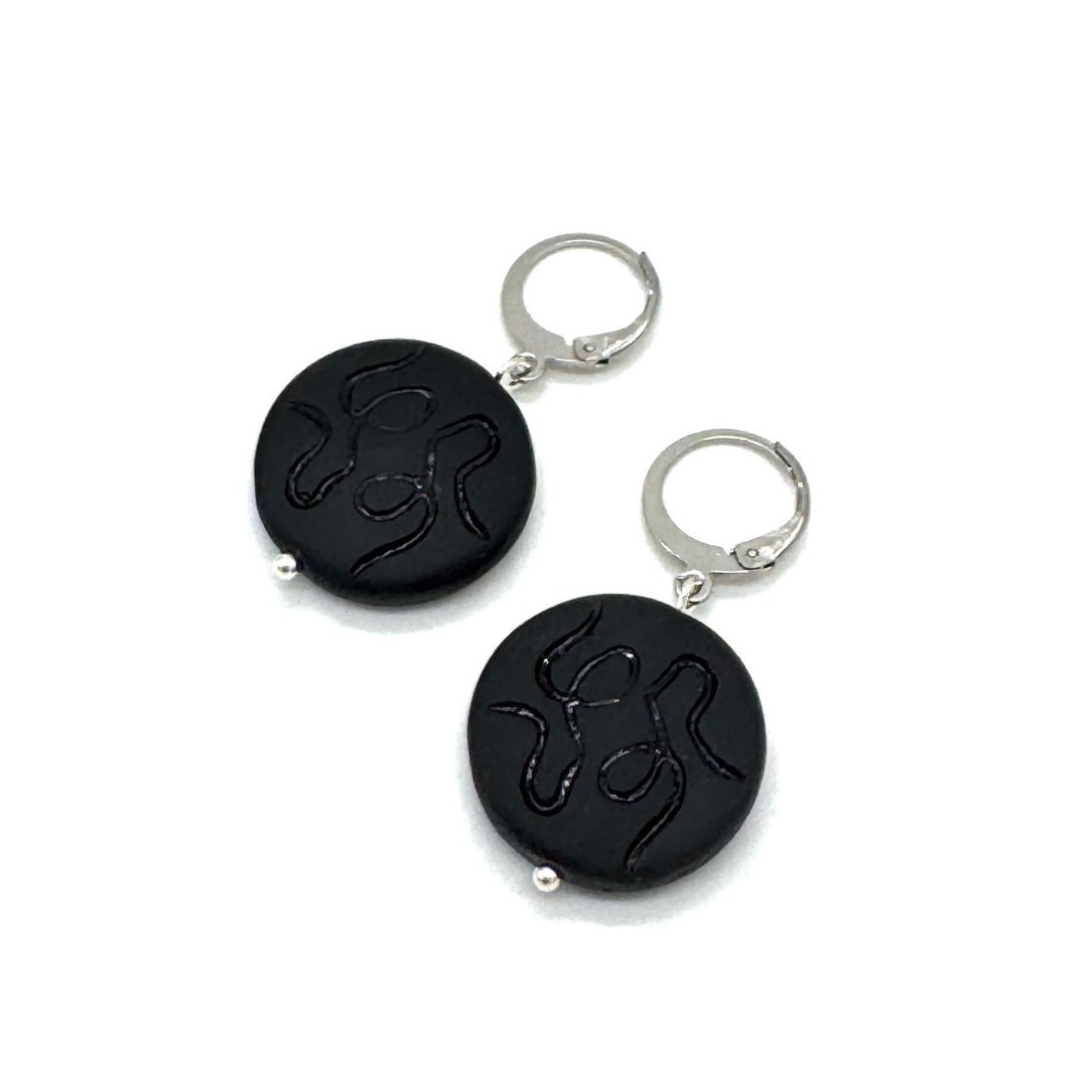 Black round keychains with silver loops on a white background