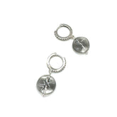 Pair of silver hoop earrings with engraved designs on a white background